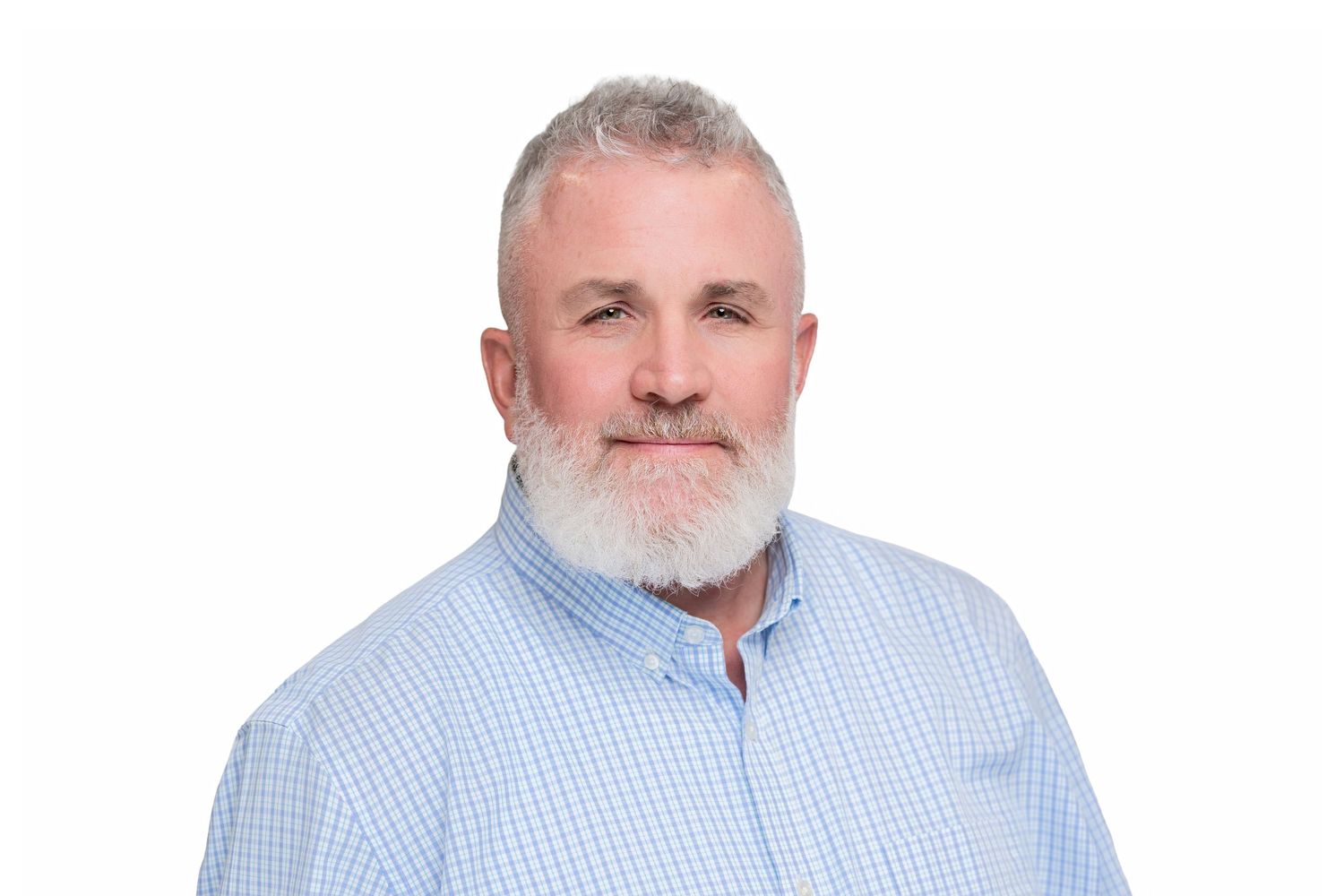 Professional headshot of a person with a white beard wearing a light blue button-down shirt against a white background.