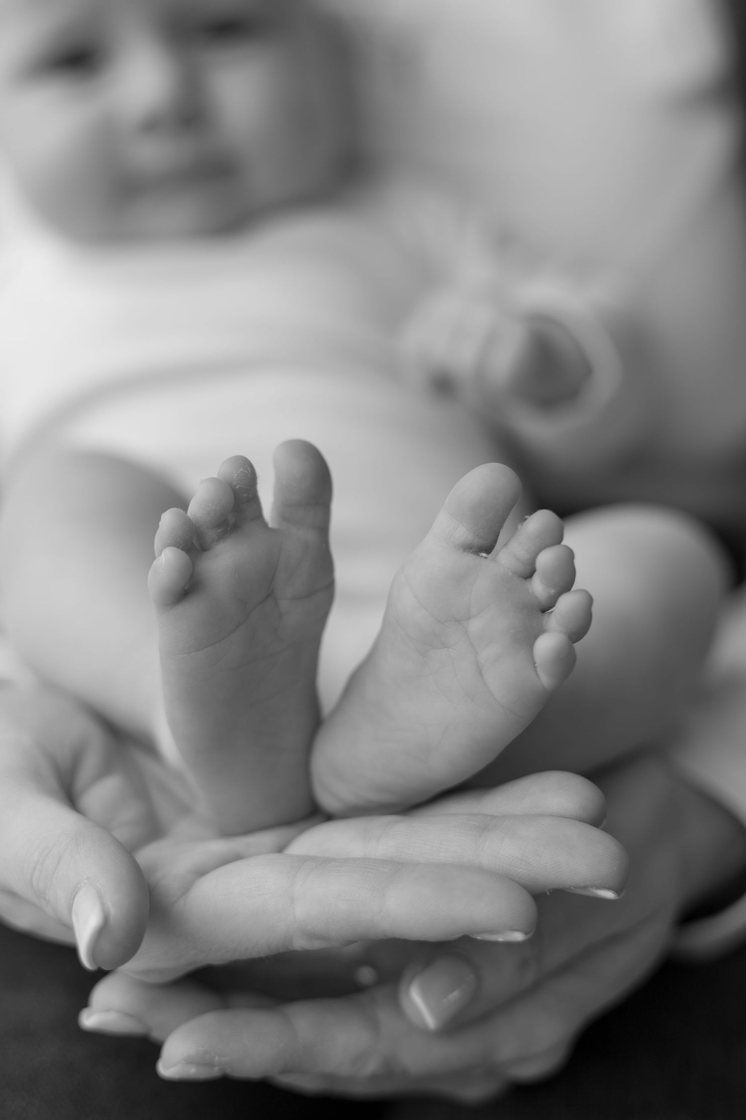 Sibling gently holding newborn baby during family photoshoot in Huddersfield home