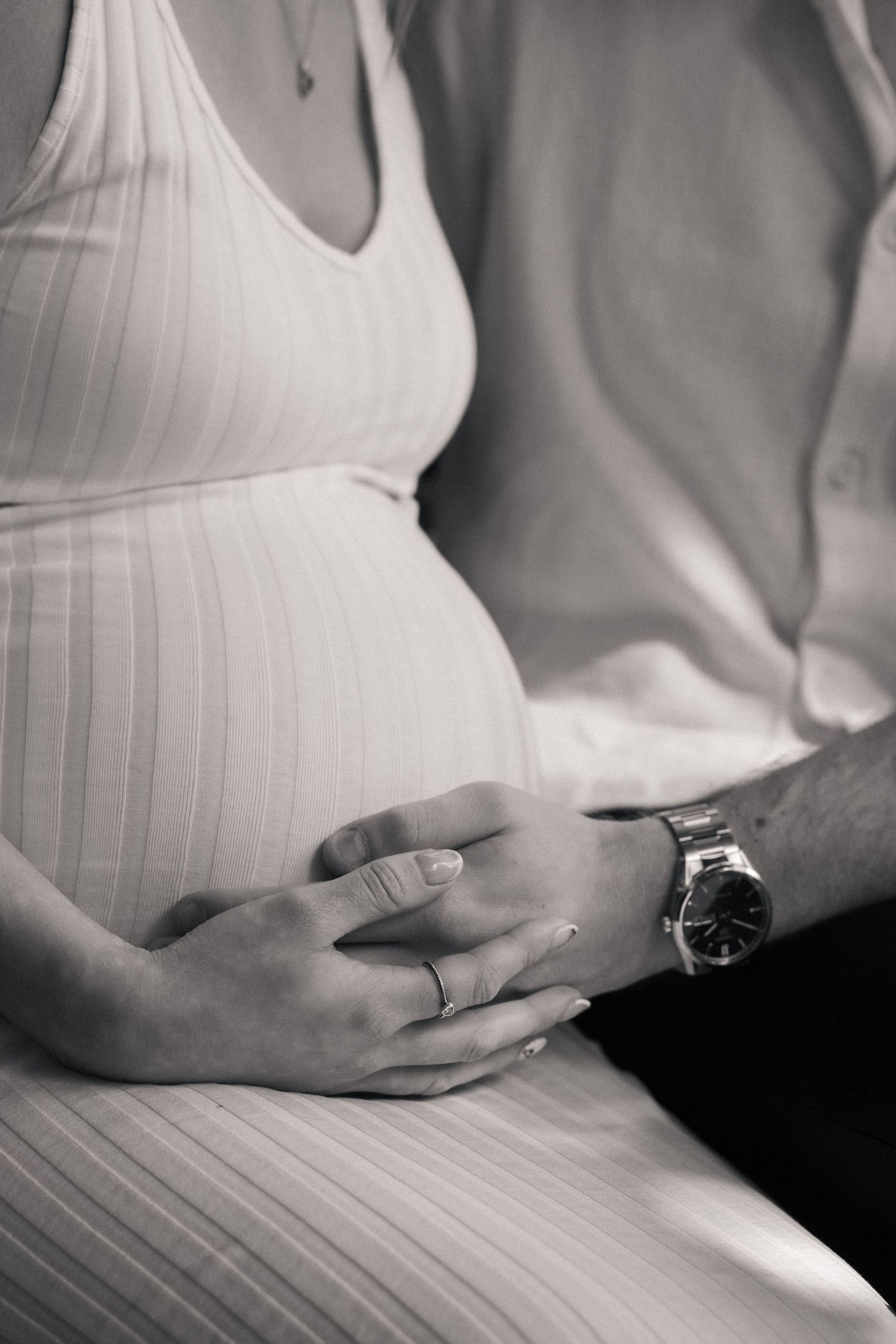 Expectant mother holding bump during outdoor maternity photoshoot in Huddersfield countryside golden hour light