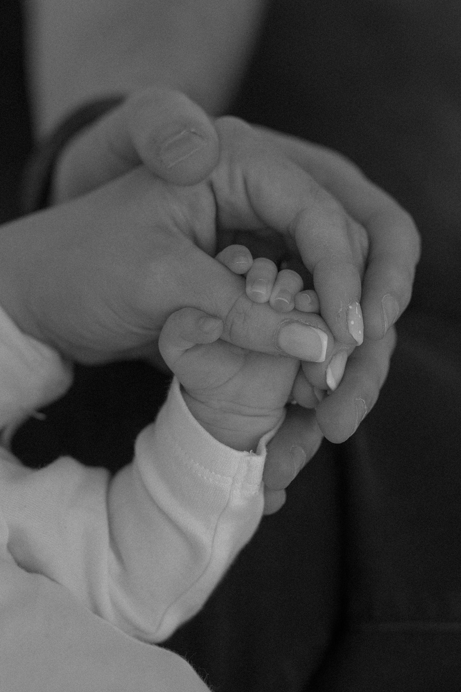 Parents looking at newborn baby in nursery during natural family photography session West Yorkshire