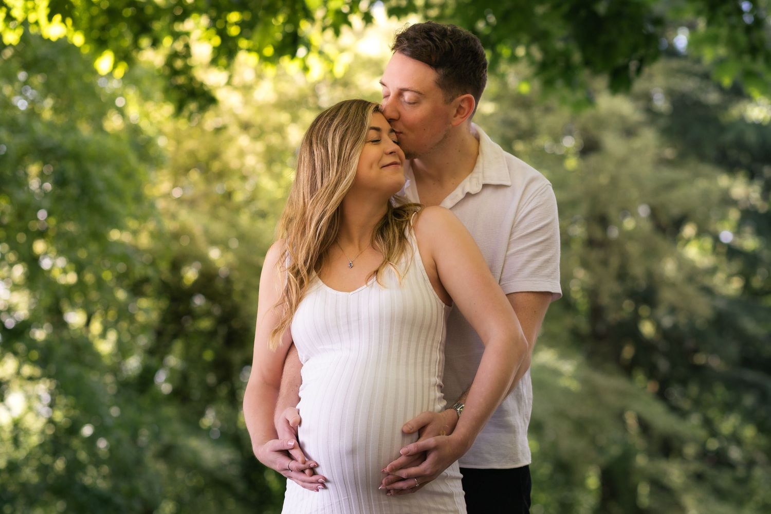 Pregnant woman smiling during relaxed maternity photoshoot in Huddersfield countryside
