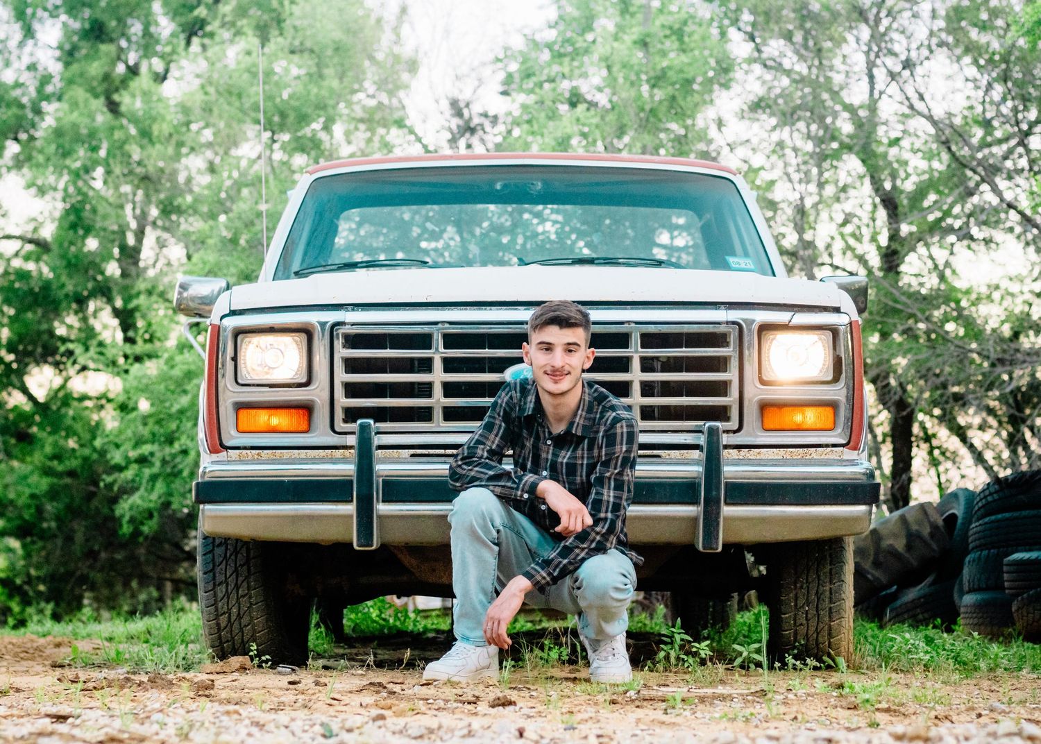 Vintage Ford pickup truck photographed from different creative angles on a dirt path.