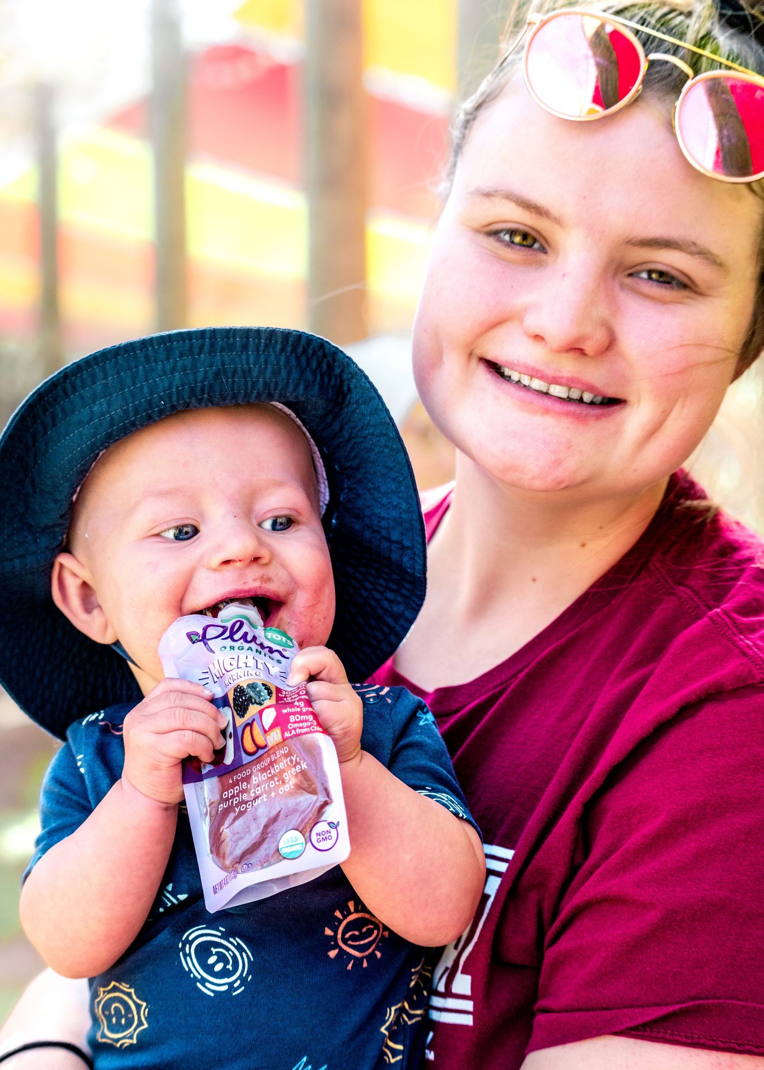 Parent and baby share playful moments while wearing casual clothing.