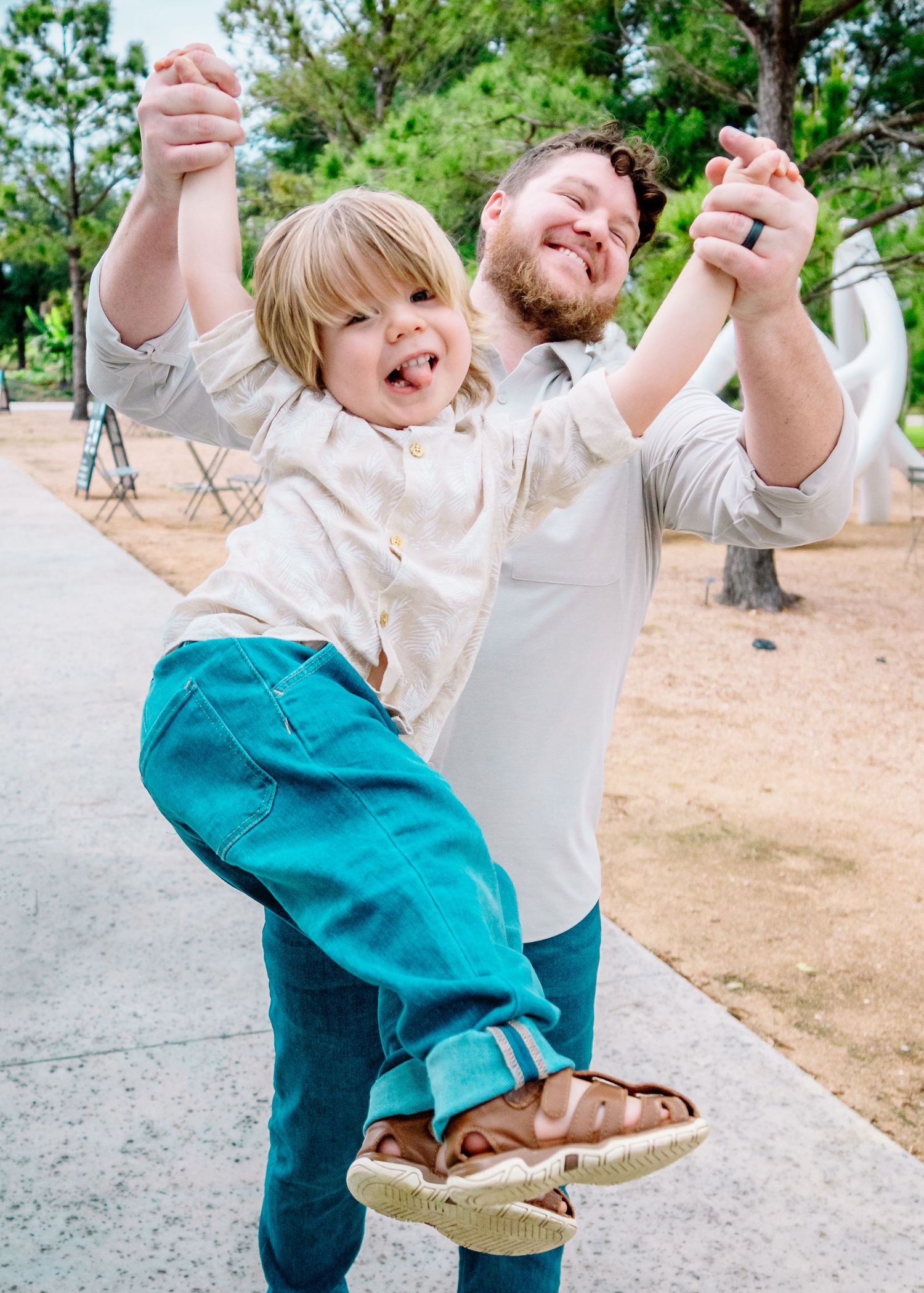 Playful jumping and dancing moments captured on a sunny outdoor path.