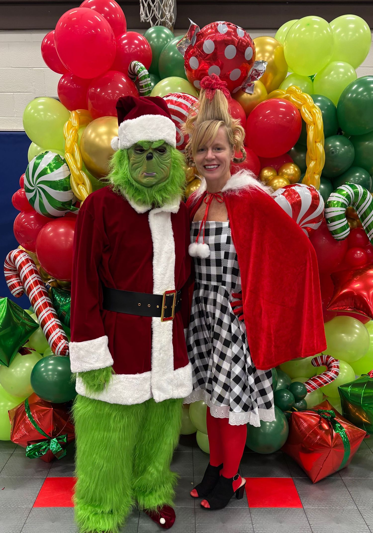 Festive Christmas scene with green and red balloon decorations and holiday characters.