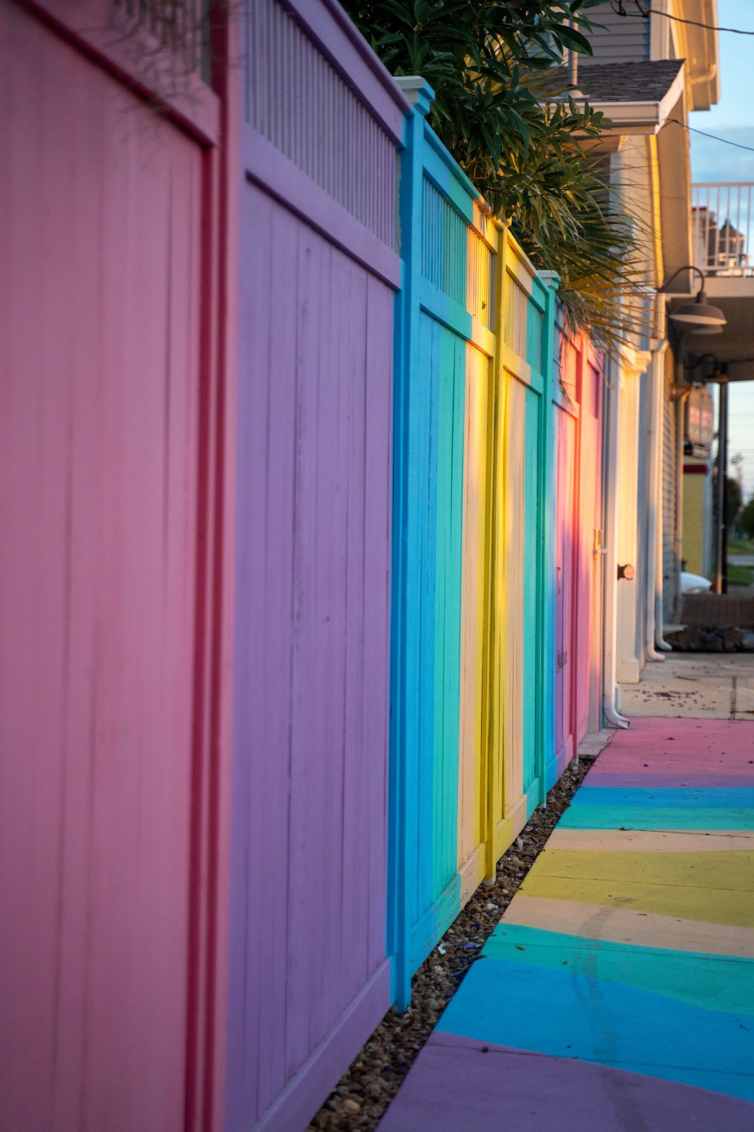 Colorful painted walls in shades of pink, purple, blue, and yellow creating a vibrant urban corridor.