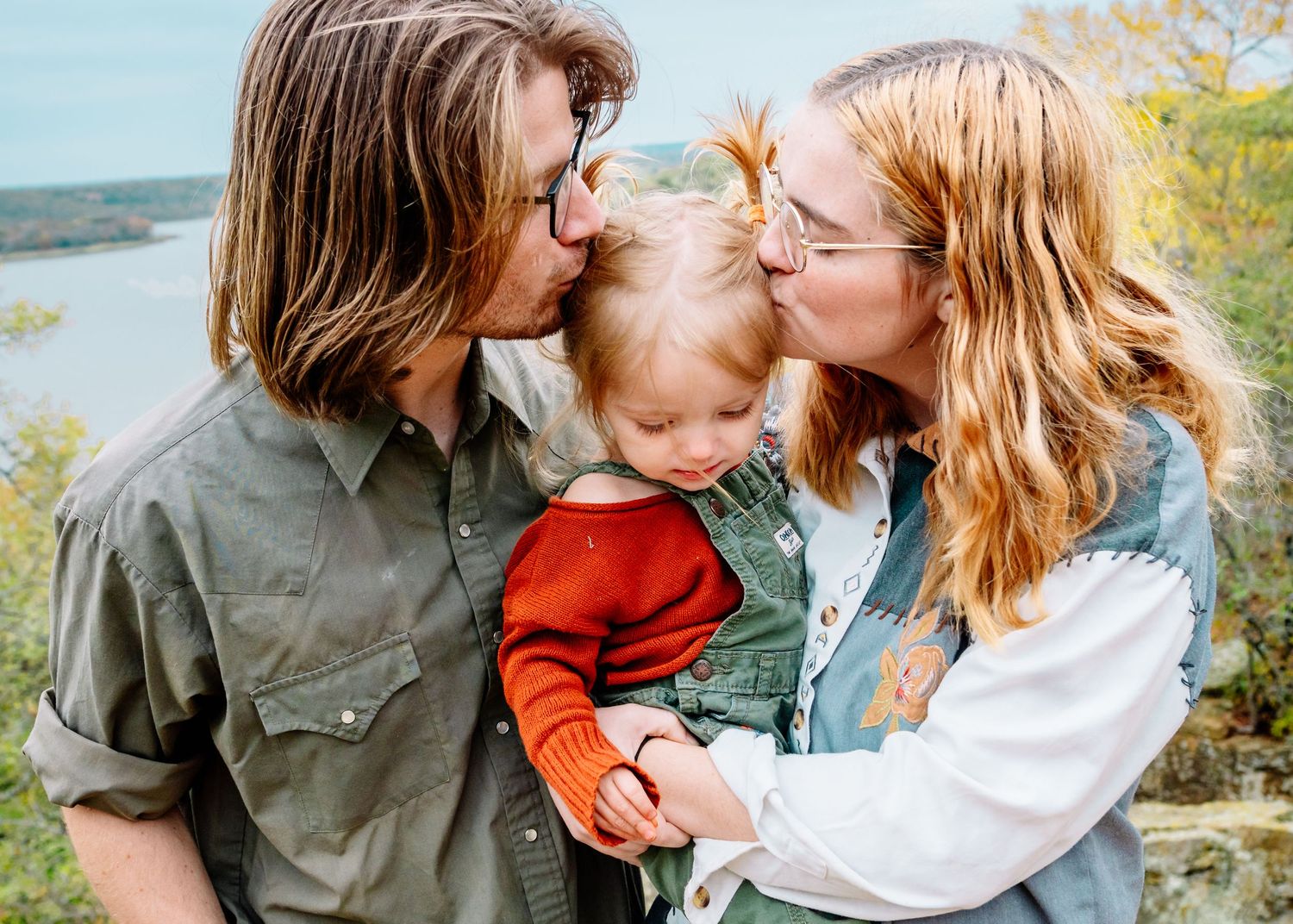 Tender moment captured between people in a natural outdoor setting.