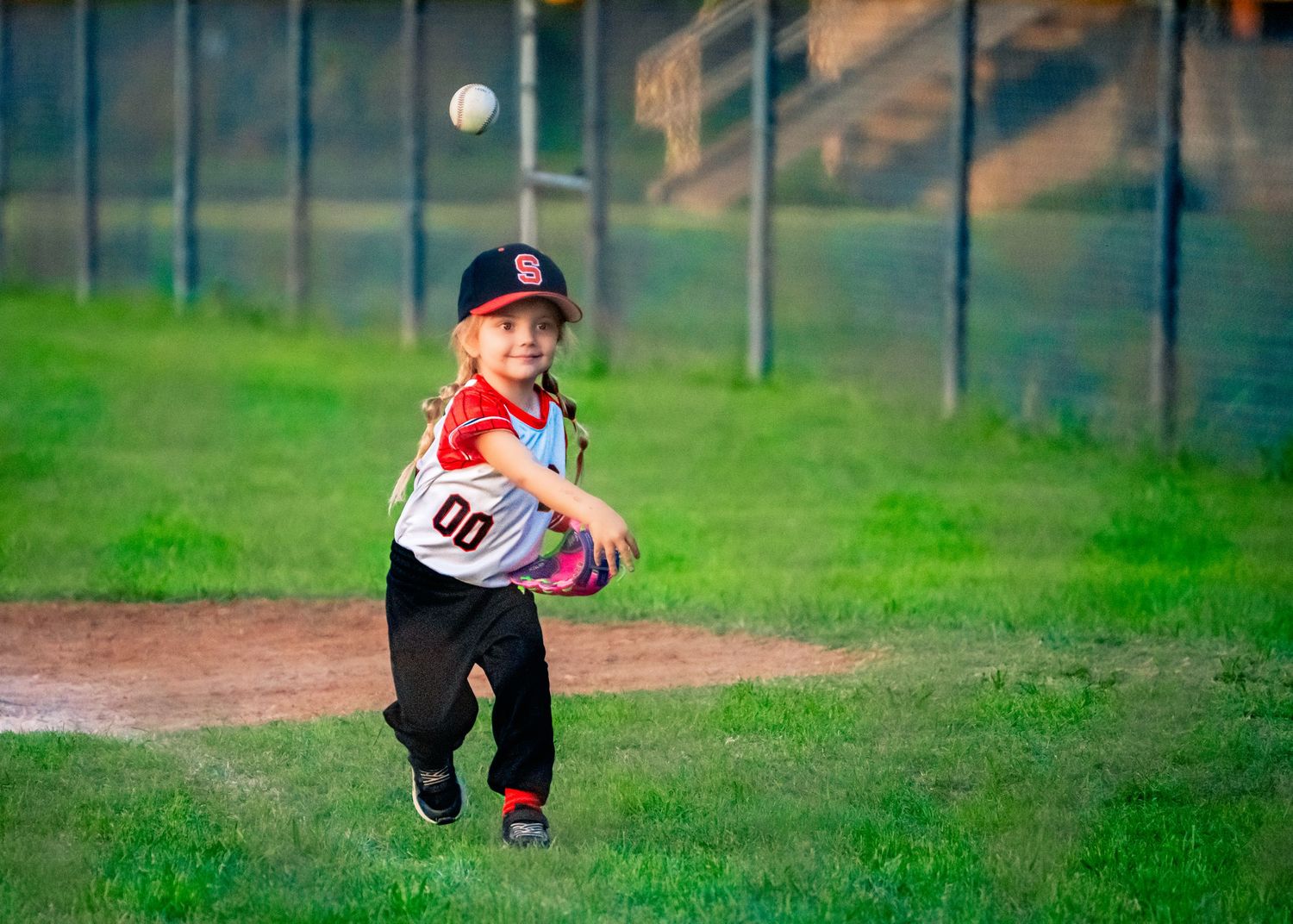 Baseball player in motion on a grassy field during practice or game.