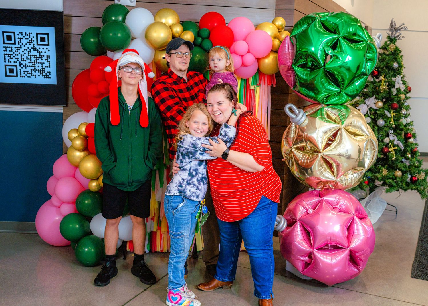Christmas-themed balloon installation with festive decorations and holiday characters.