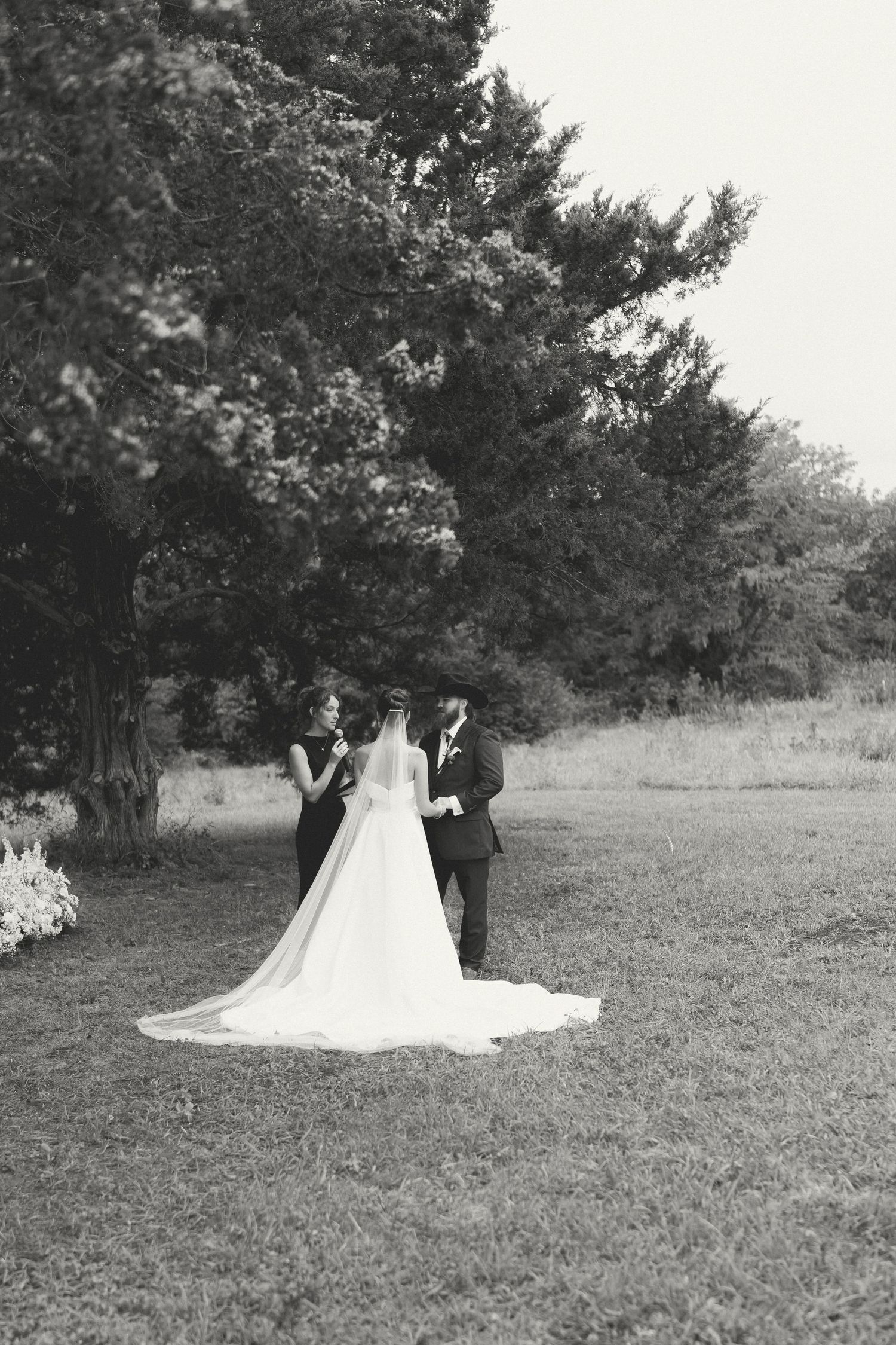 Black and white wedding photos capture romantic moments in a scenic outdoor setting.