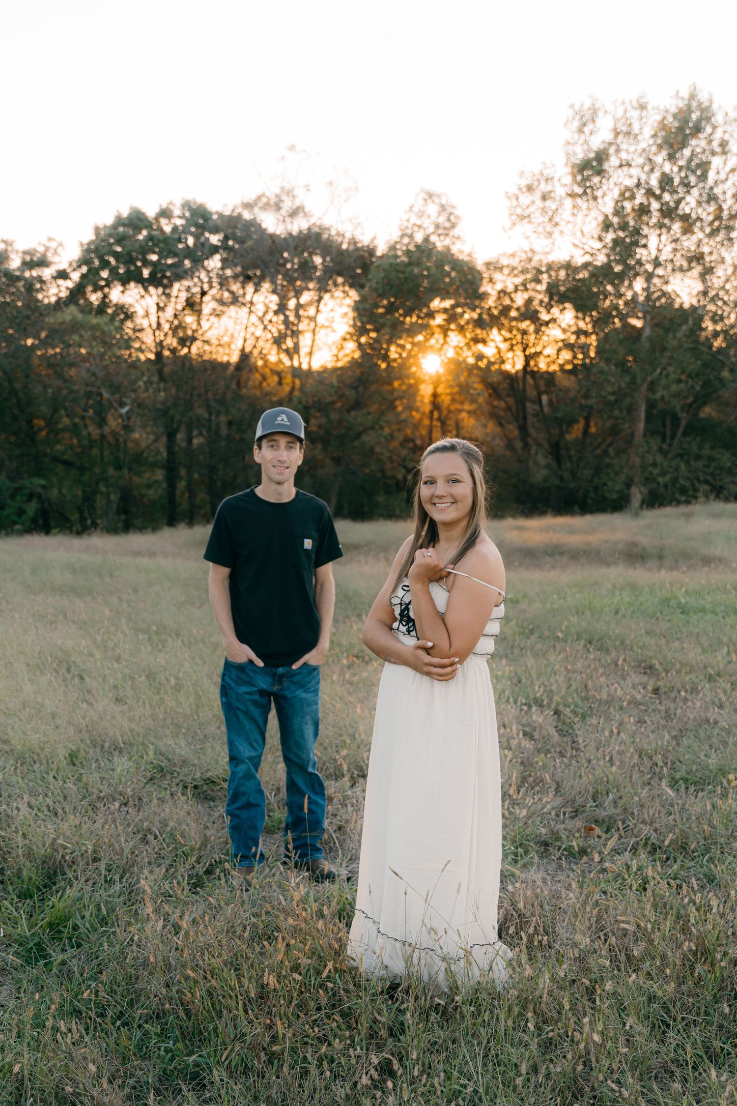 Sunset photoshoot in a rustic field with golden light.