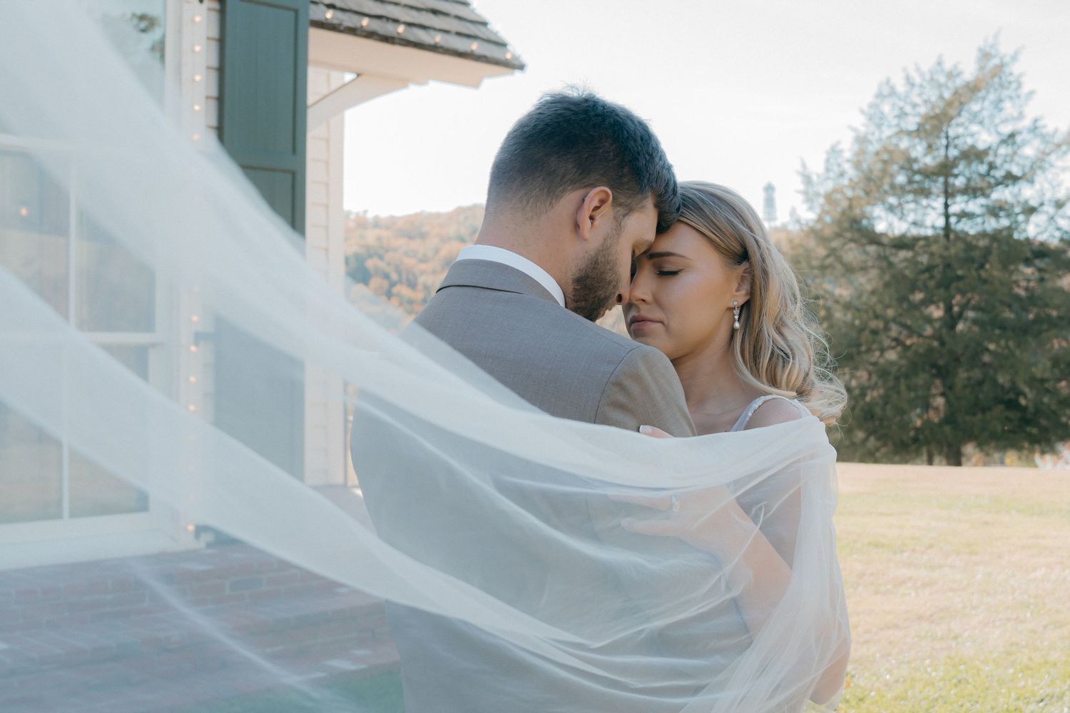 Wedding veil flowing in the breeze during an outdoor photoshoot.