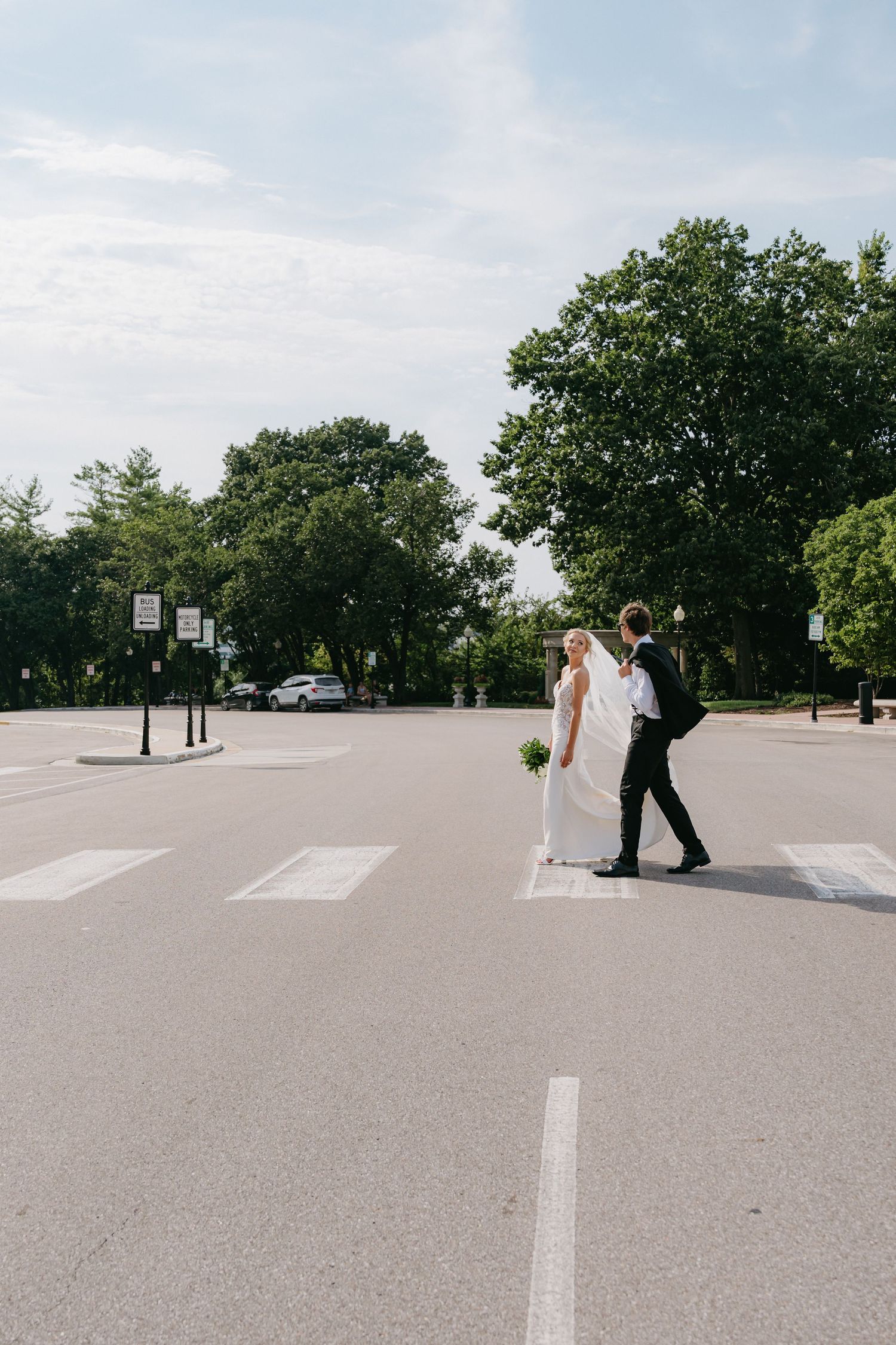 Newlyweds holding hands and smiling during their wedding day