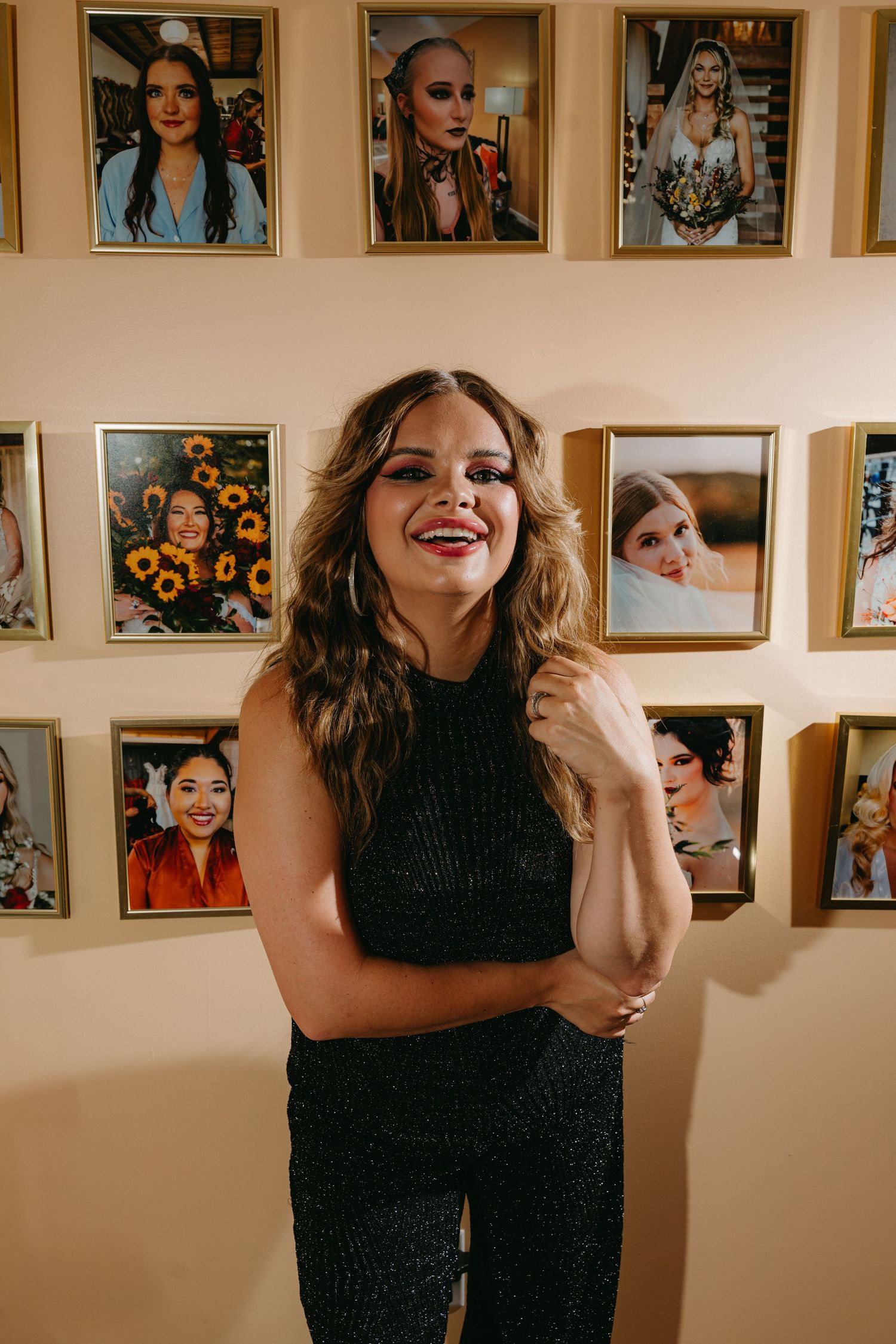 A series of candid photos showing someone in a black dress laughing and posing against a wall with framed pictures.
