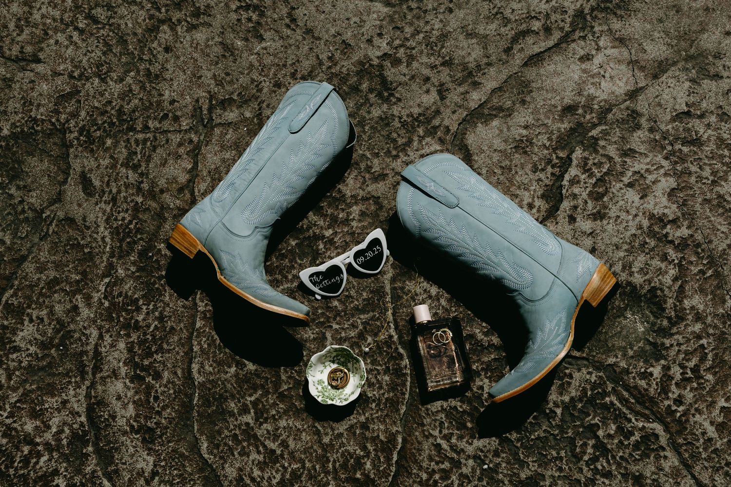 Stylish gray boots arranged artistically on dark textured background.