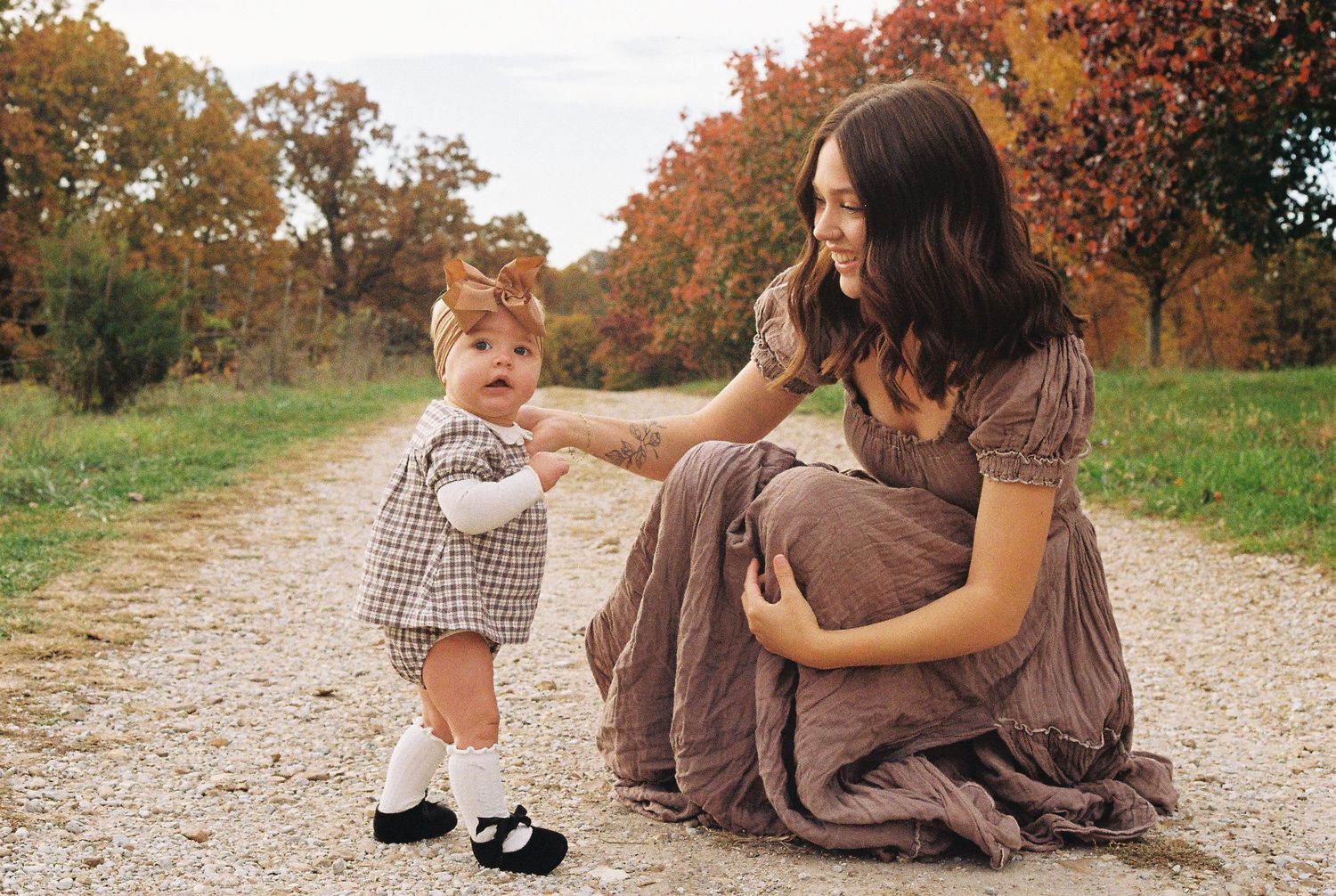 Heartwarming autumn scene on a dirt path with fall foliage in the background.