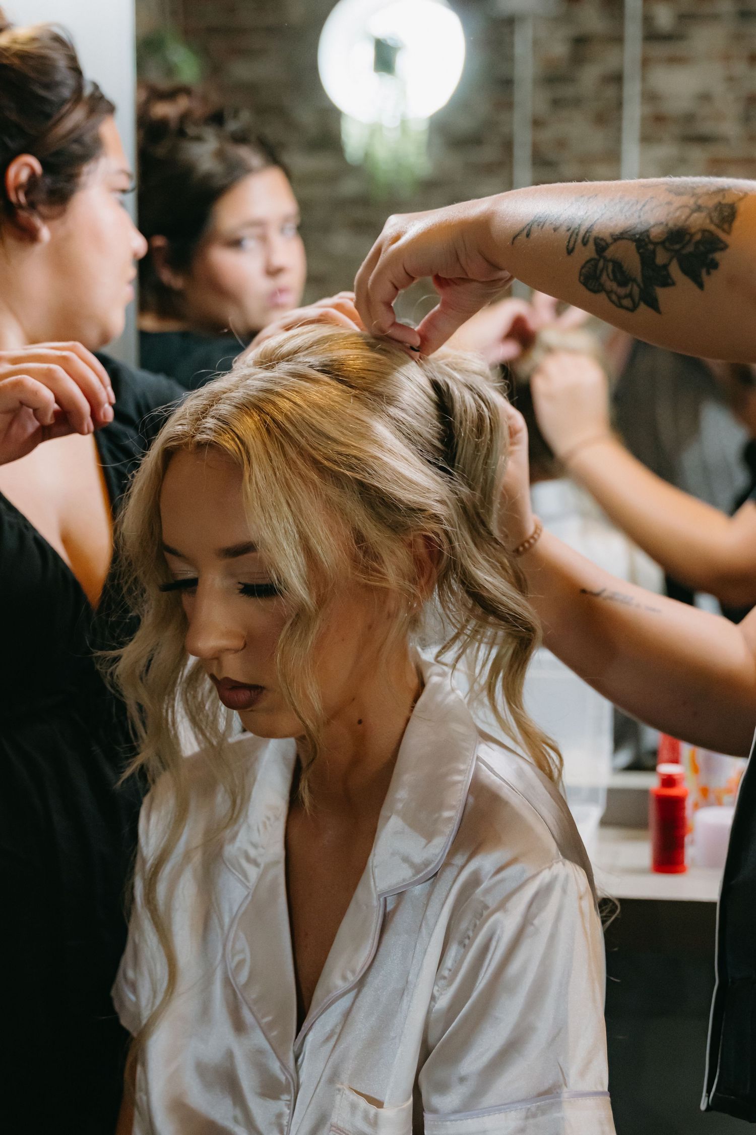 Wedding day preparation scene with styling taking place indoors.
