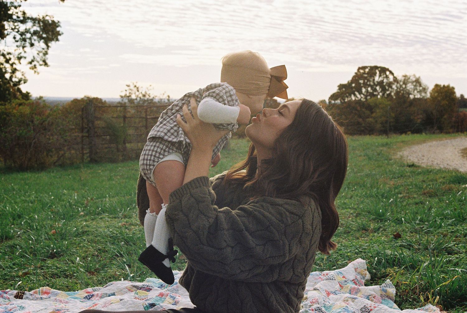 Sweet autumn picnic scene in a grassy field at sunset.