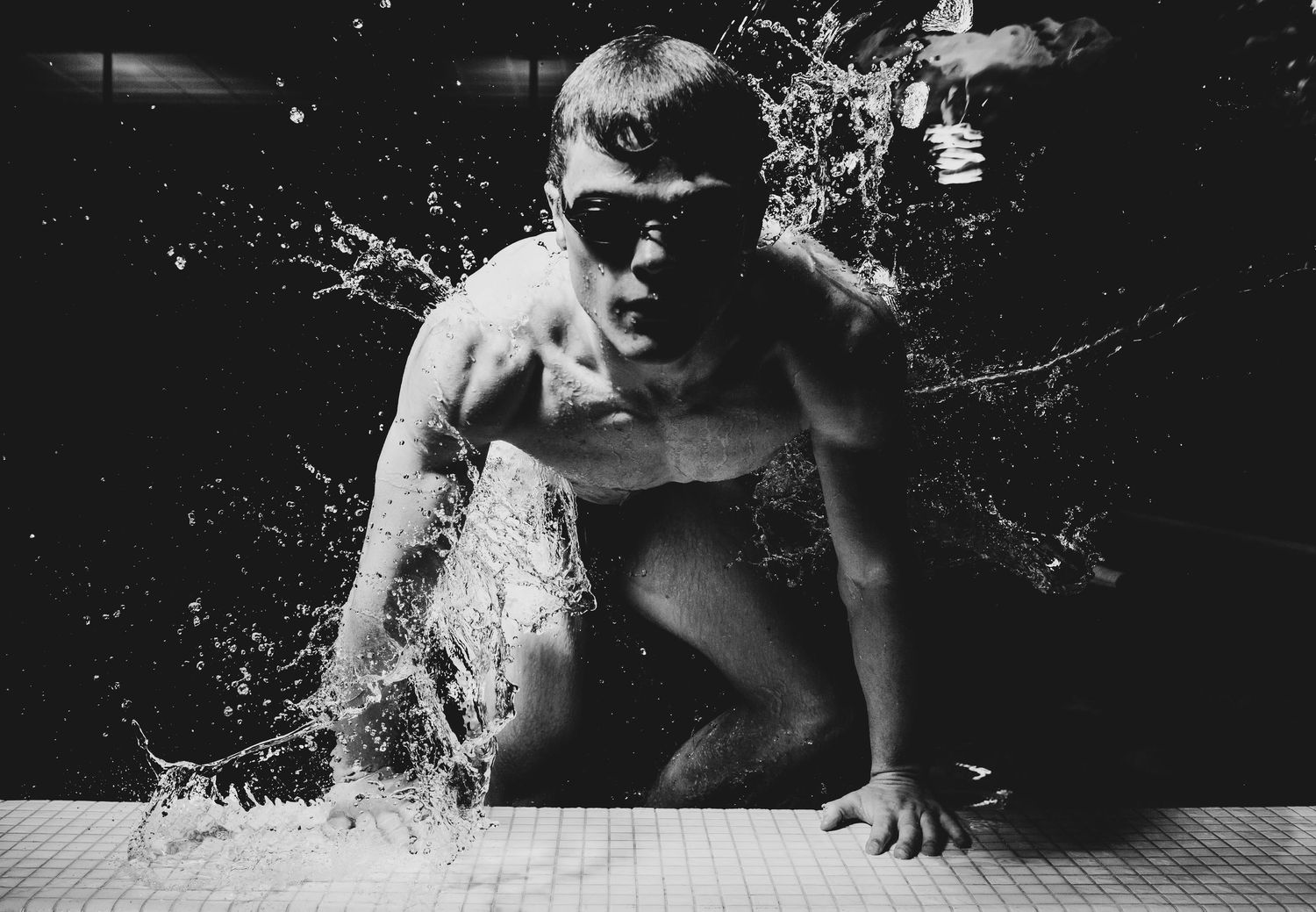 Underwater sequence of a swimmer diving into a pool with bubbles and splashes creating dynamic motion effects.