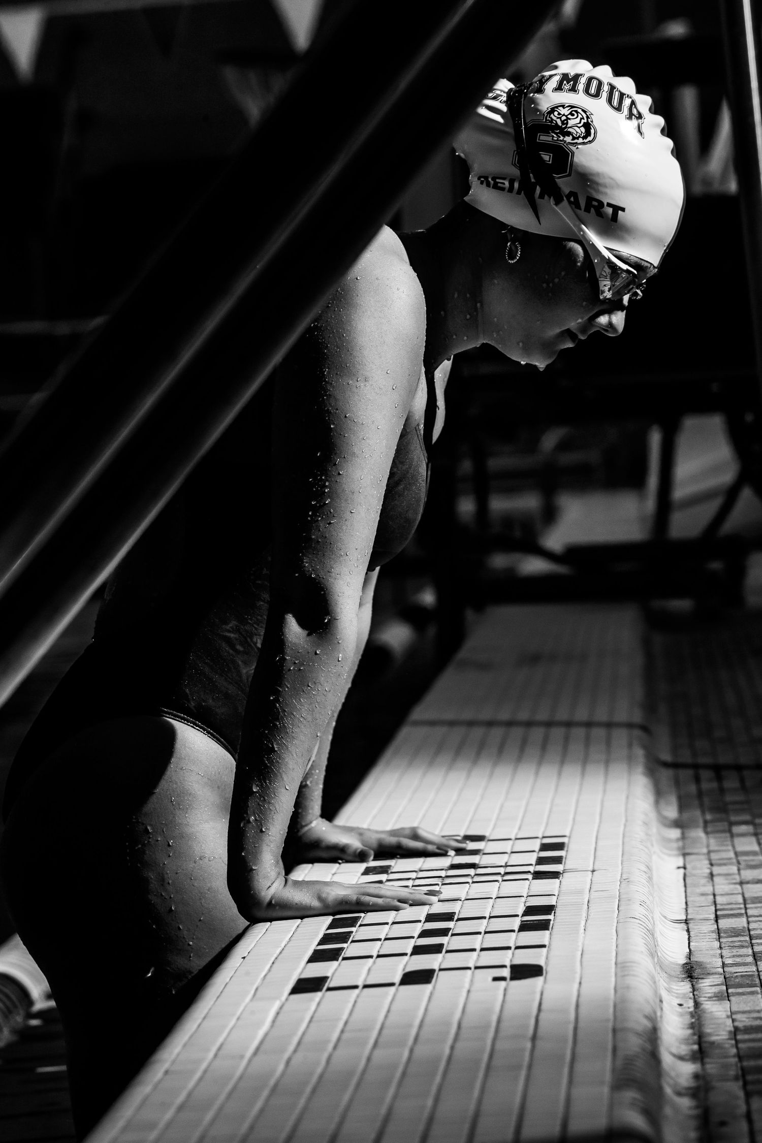 Black and white artistic sequence showing hands on swim deck in dramatic lighting.