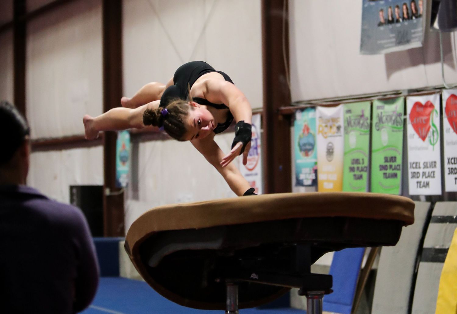 gymnast hurdles onto vault table during gymnastics meet