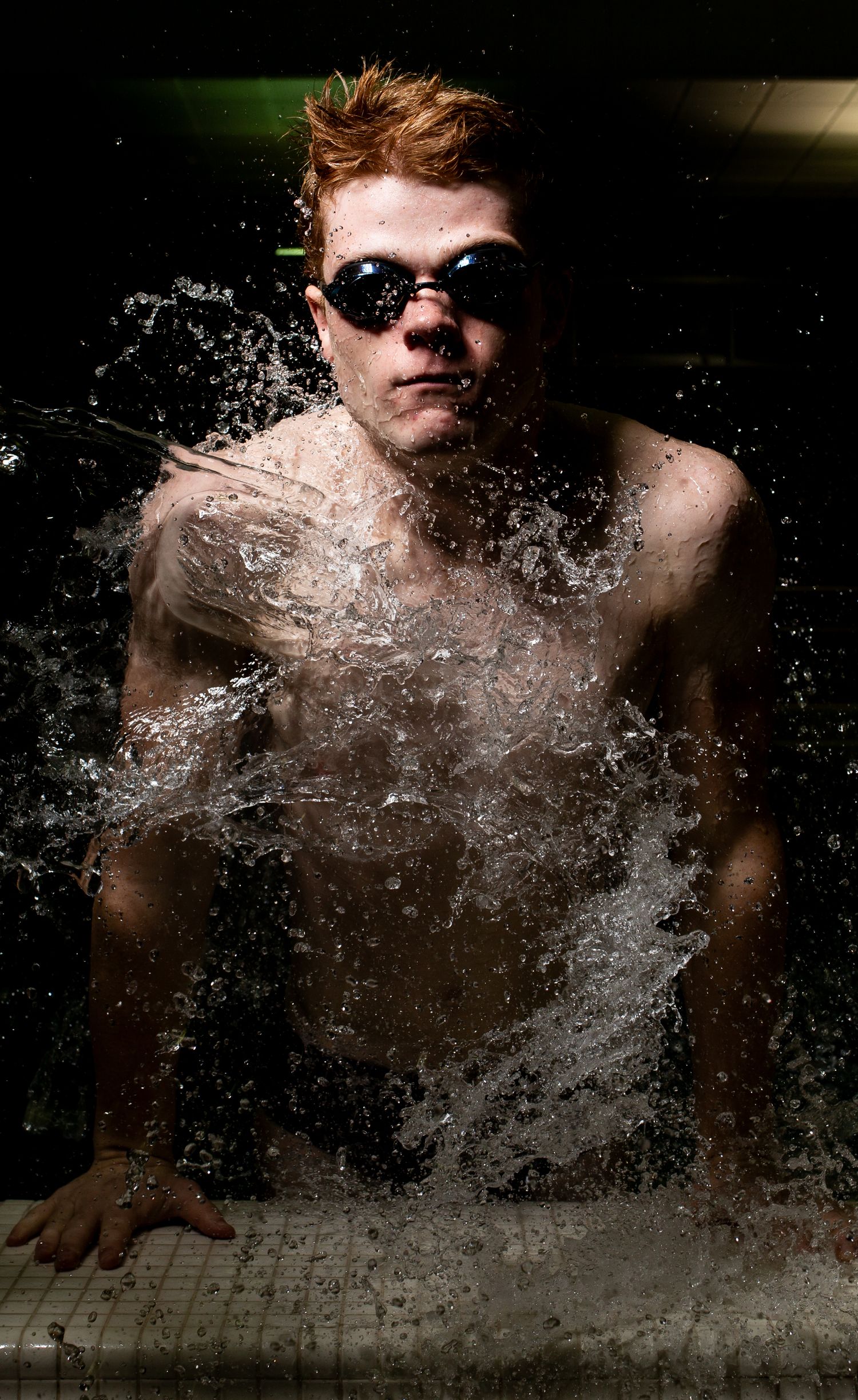 A dramatic sequence showing water splashing and spraying in front of a dark background with sunglasses visible.