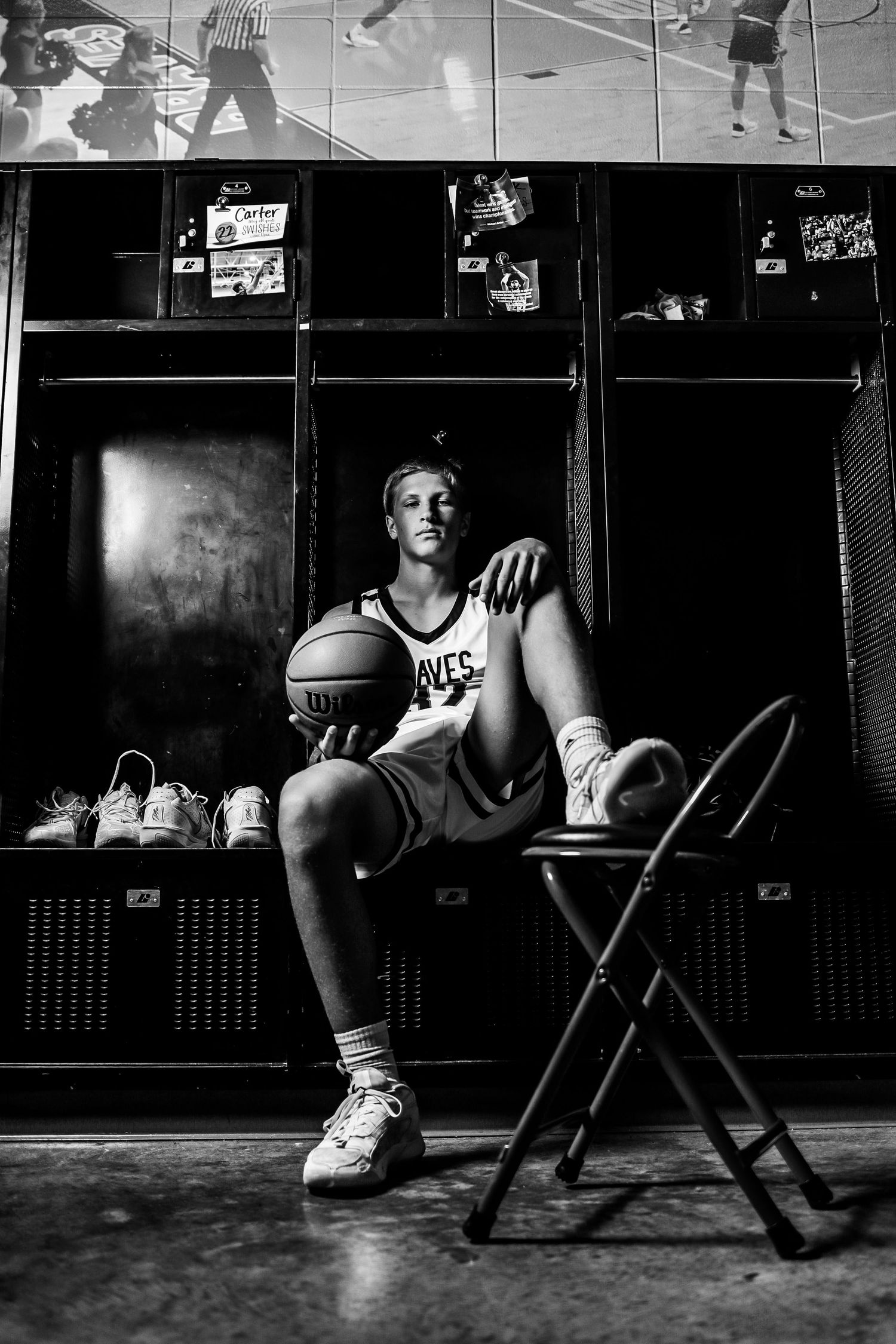 A series of black and white photos showing basketball players sitting in locker room benches in dramatic lighting.