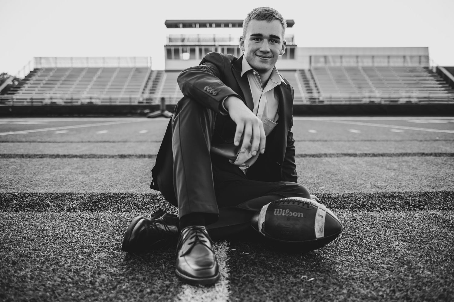 A collection of black and white photos showing senior sitting on a sports field.