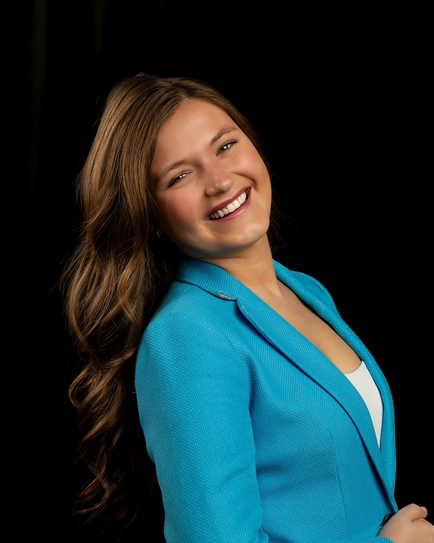 Professional portrait series showing a bright turquoise blazer against a dark background in four dynamic poses.