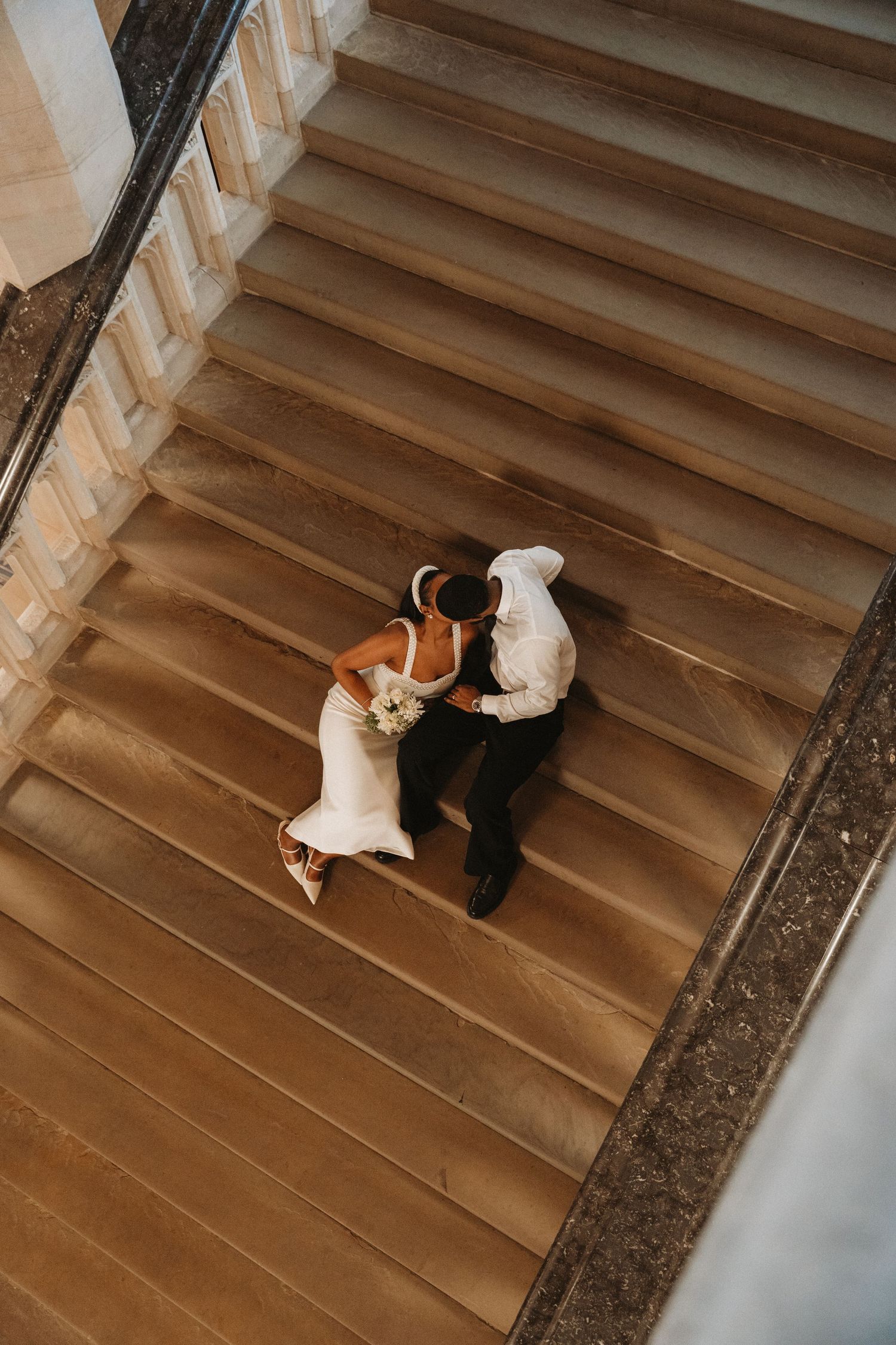 A sequence of five photos showing a couple dancing on stone steps in a romantic moment.