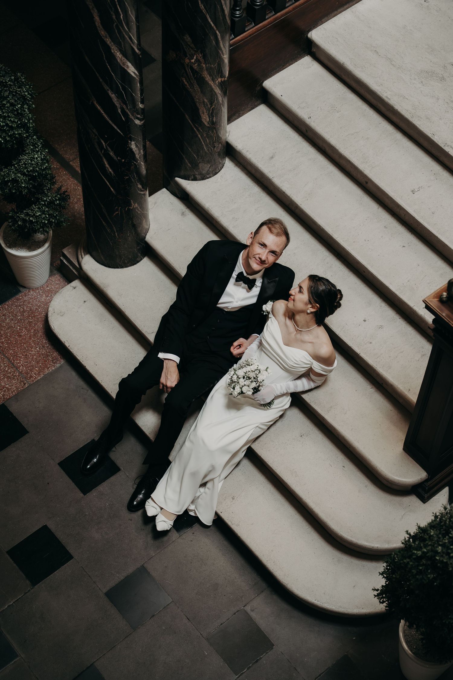 Artistic overhead view of wedding couple dancing on geometric patterned floor.