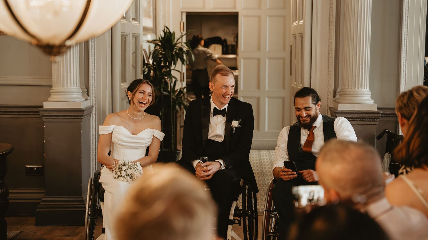 Interior shot of elegant wedding venue with ornate white columns and decorative details.