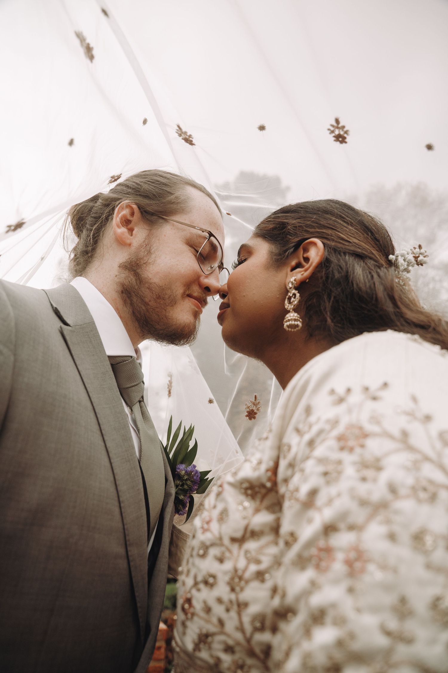 An intimate wedding moment captured in soft, dreamy lighting.