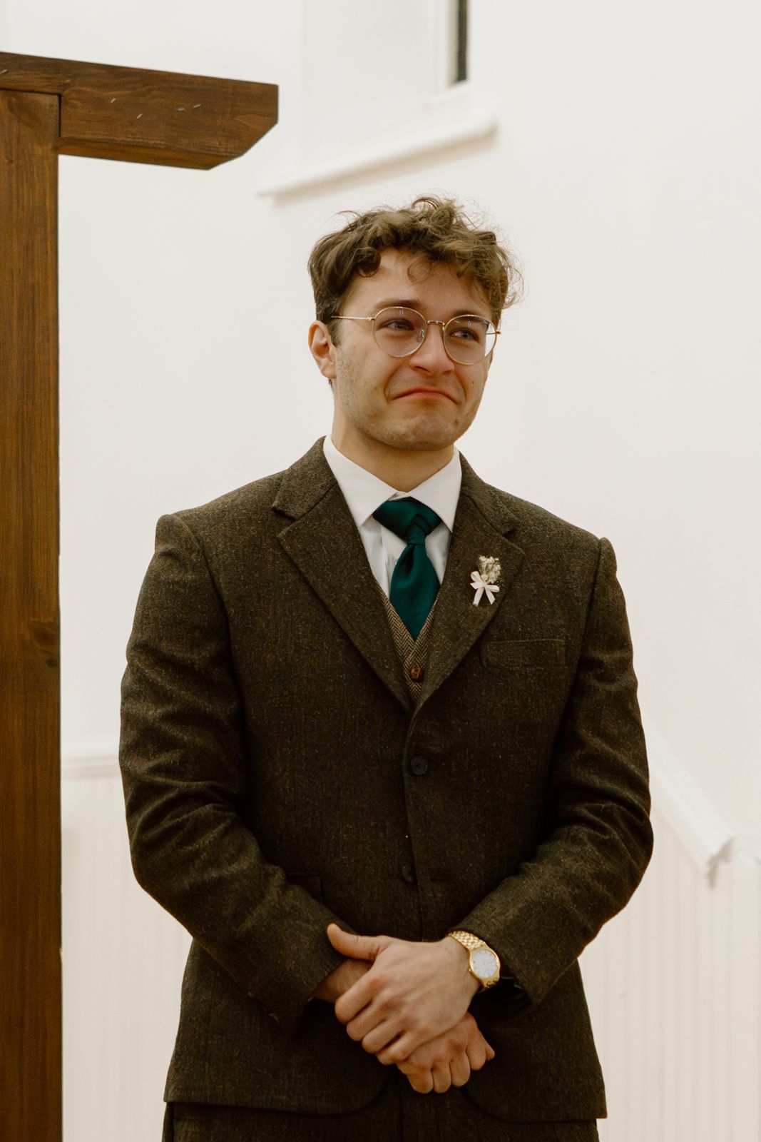 A groom cries as he watches his bride walk down the aisle.