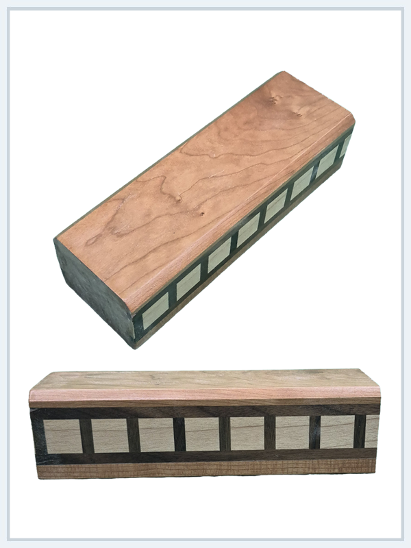 Handcrafted wooden box with green trim and decorative square inlays, shown from two angles highlighting natural wood grain.