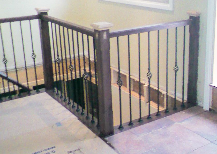 Decorative Metal pickets and wooden railing.