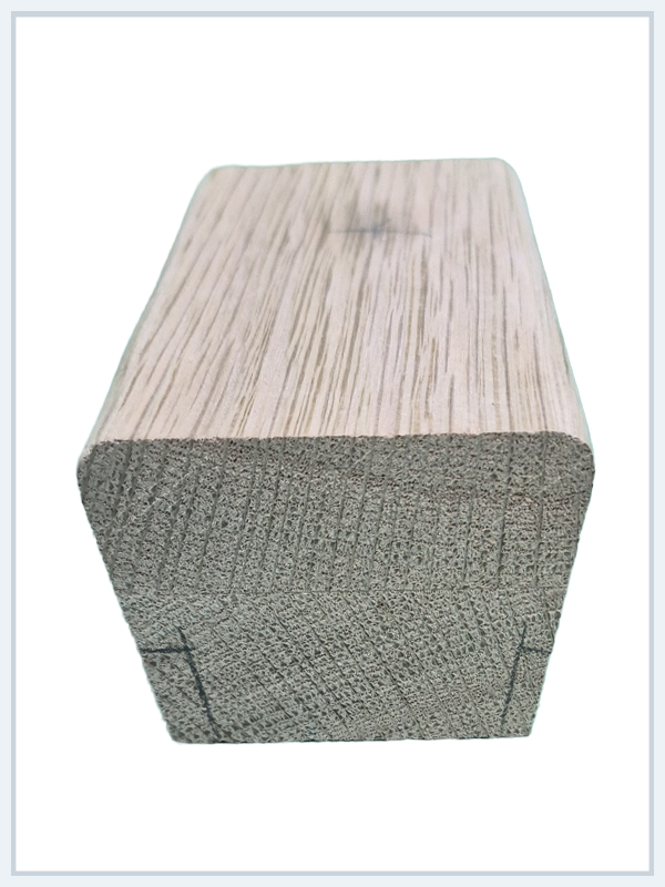 Close-up of a rectangular wood block showing natural grain texture on top and rough cut ends.