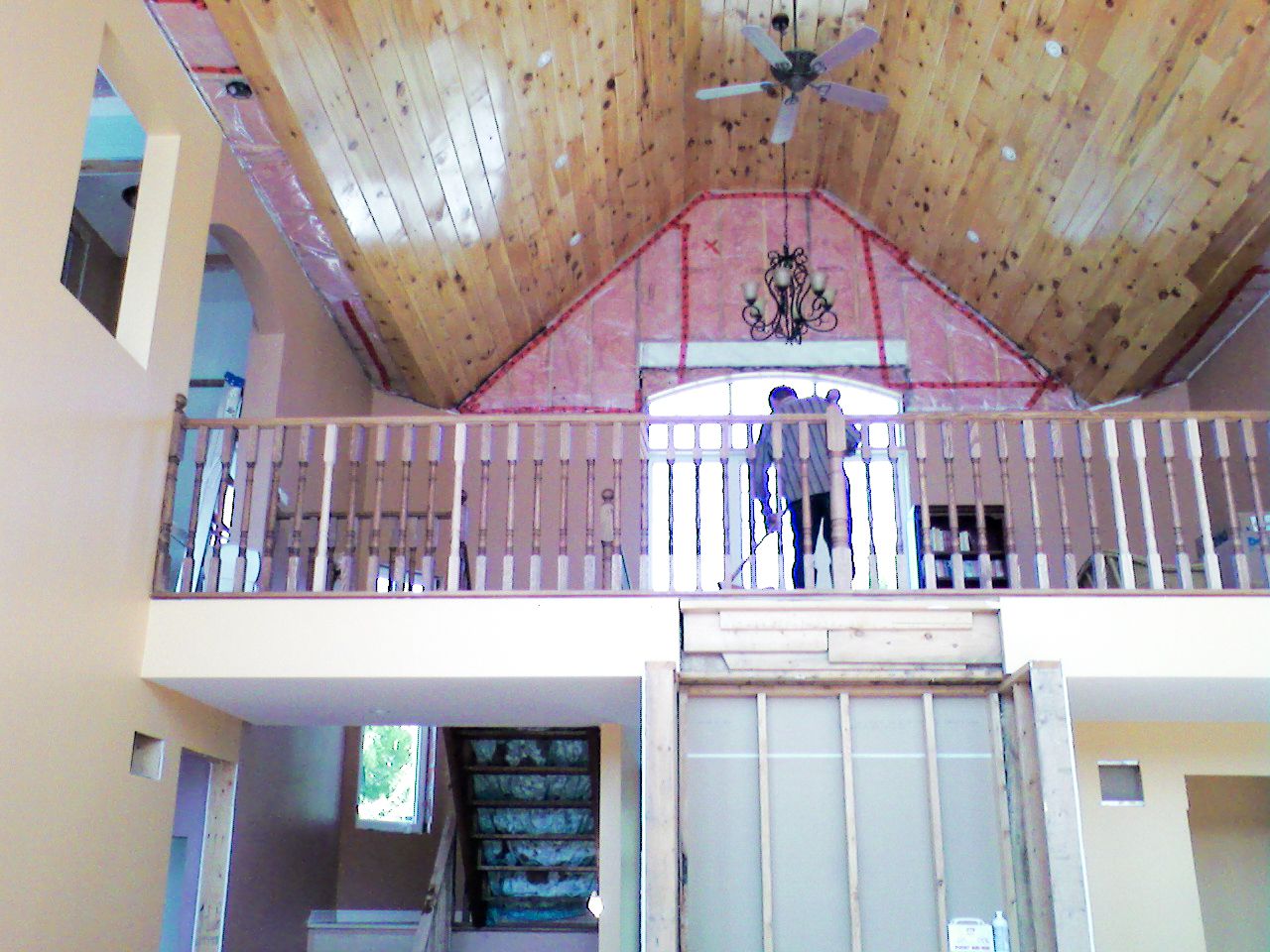 Wide-angle view of a home interior featuring a second-floor balcony railing.