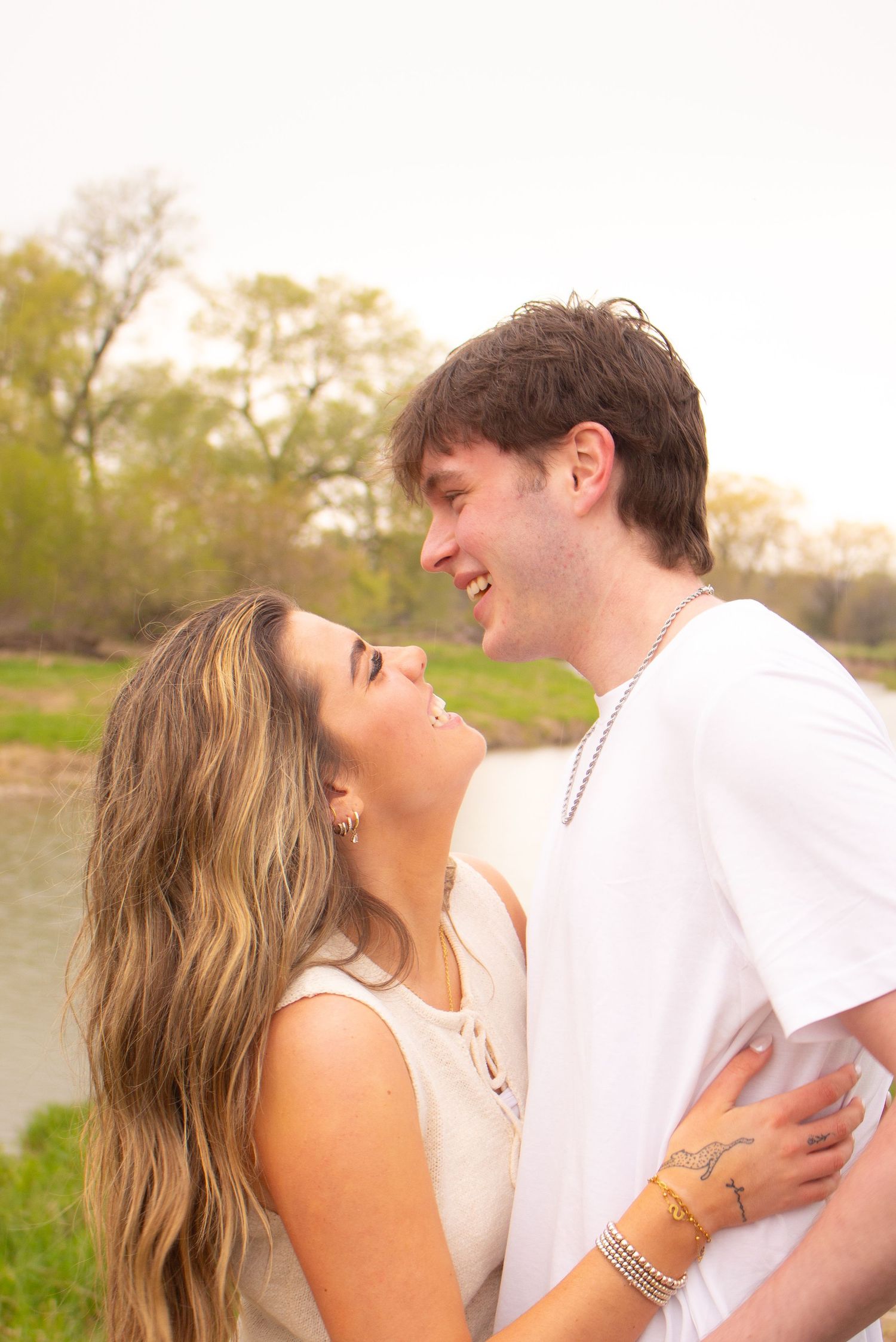 Couple sharing sweet moments outdoors during warm, candid, couples photography session.