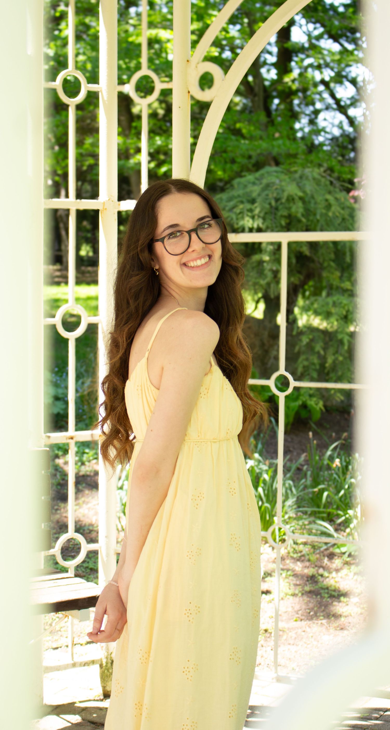 Beautiful Kate posing beneath a garden arch during an outdoor portrait  + friends photoshoot.