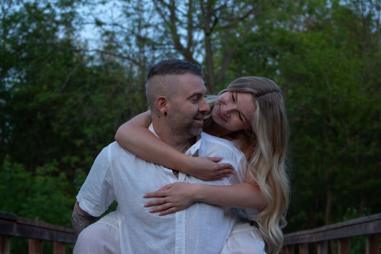 Father and daughter laughing together during their outdoor family session.
