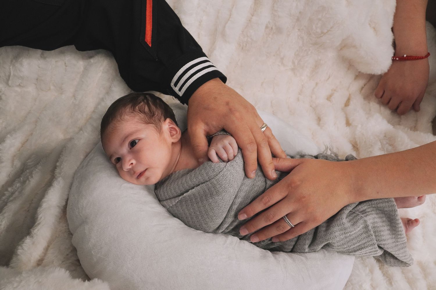 A series of connected images showing someone sleeping peacefully in soft gray bedding.