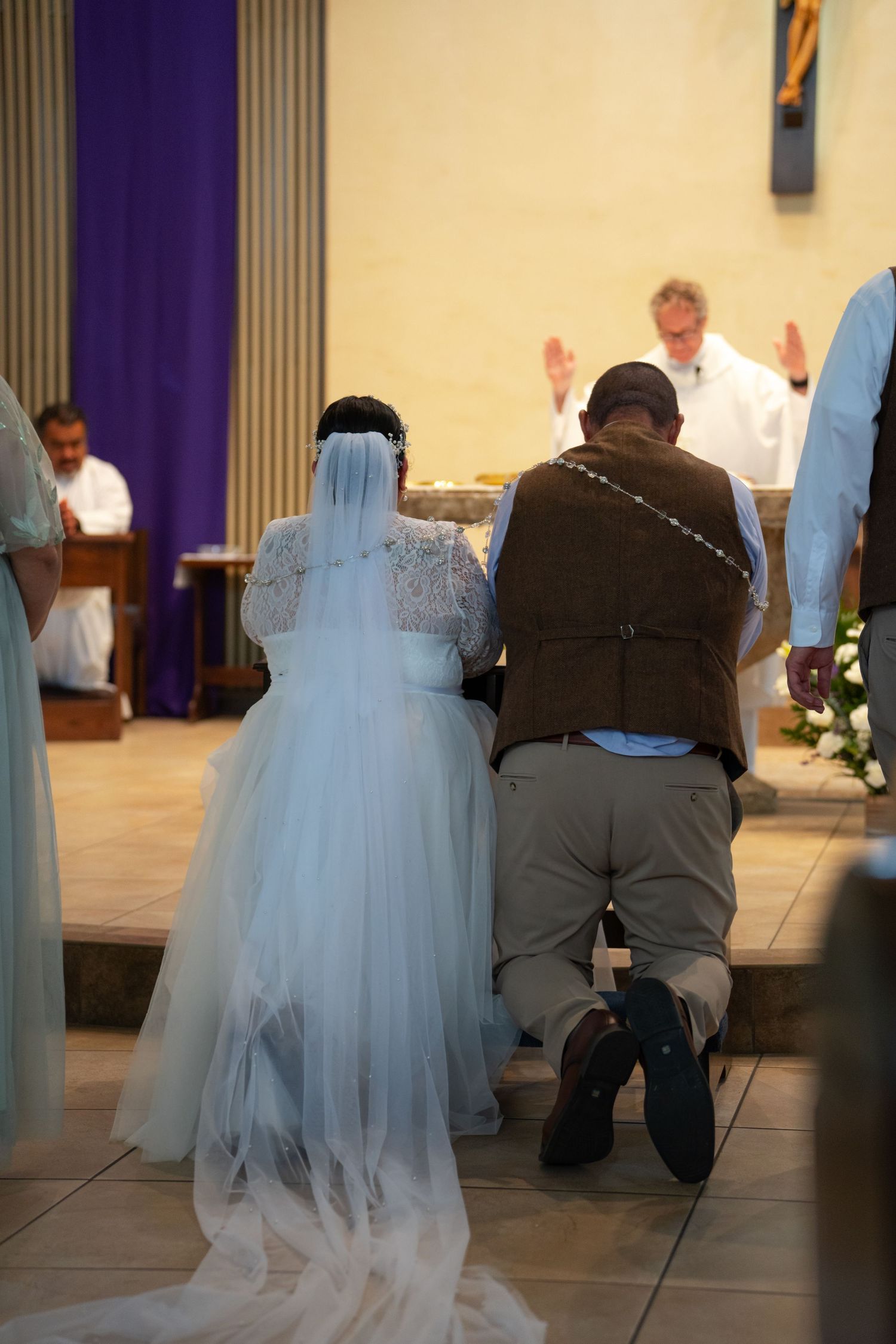 A series of wedding ceremony photos showing a couple kneeling at the altar in a church.