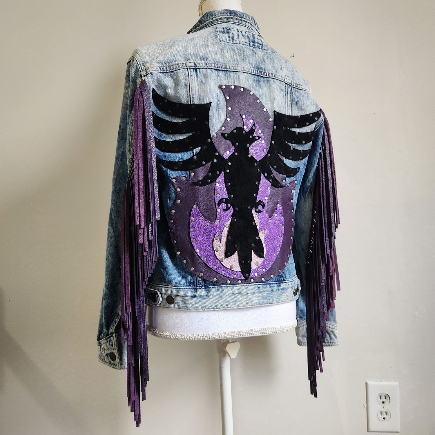 Customized denim jacket with purple fringe, hand-painted phoenix design, and moon motif on the back.