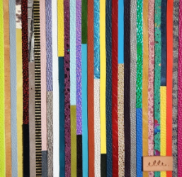 Colorful vertical strips of patterned fabric arranged in a vibrant collage-style textile art piece.