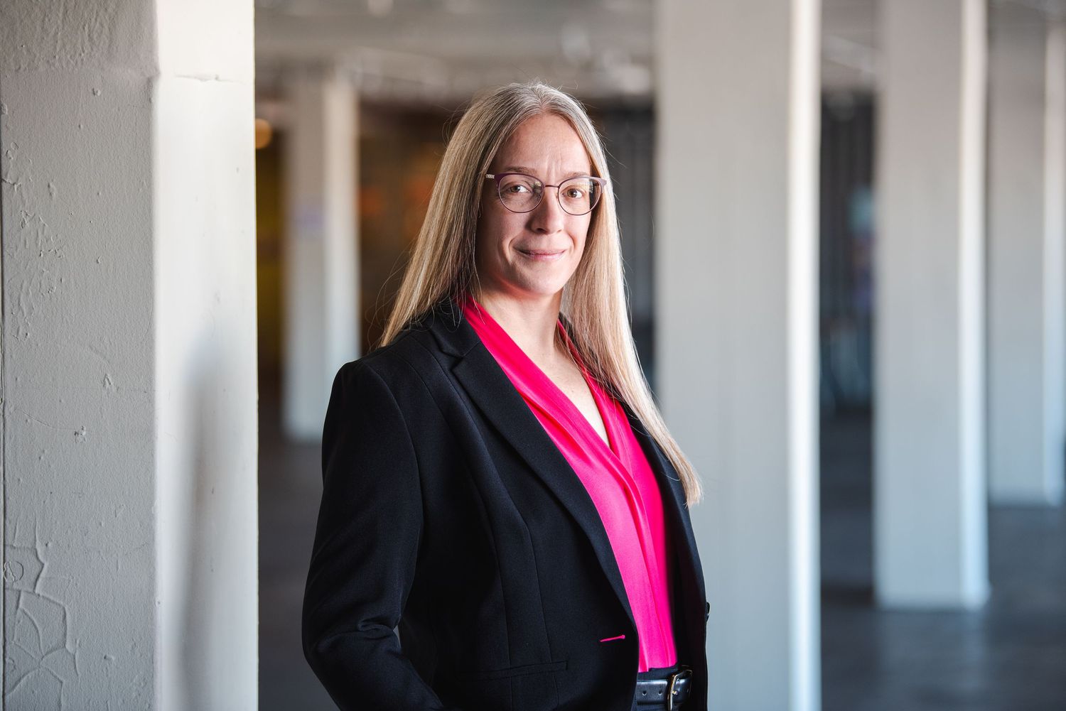 Professional headshots of a person in business attire against a light background.