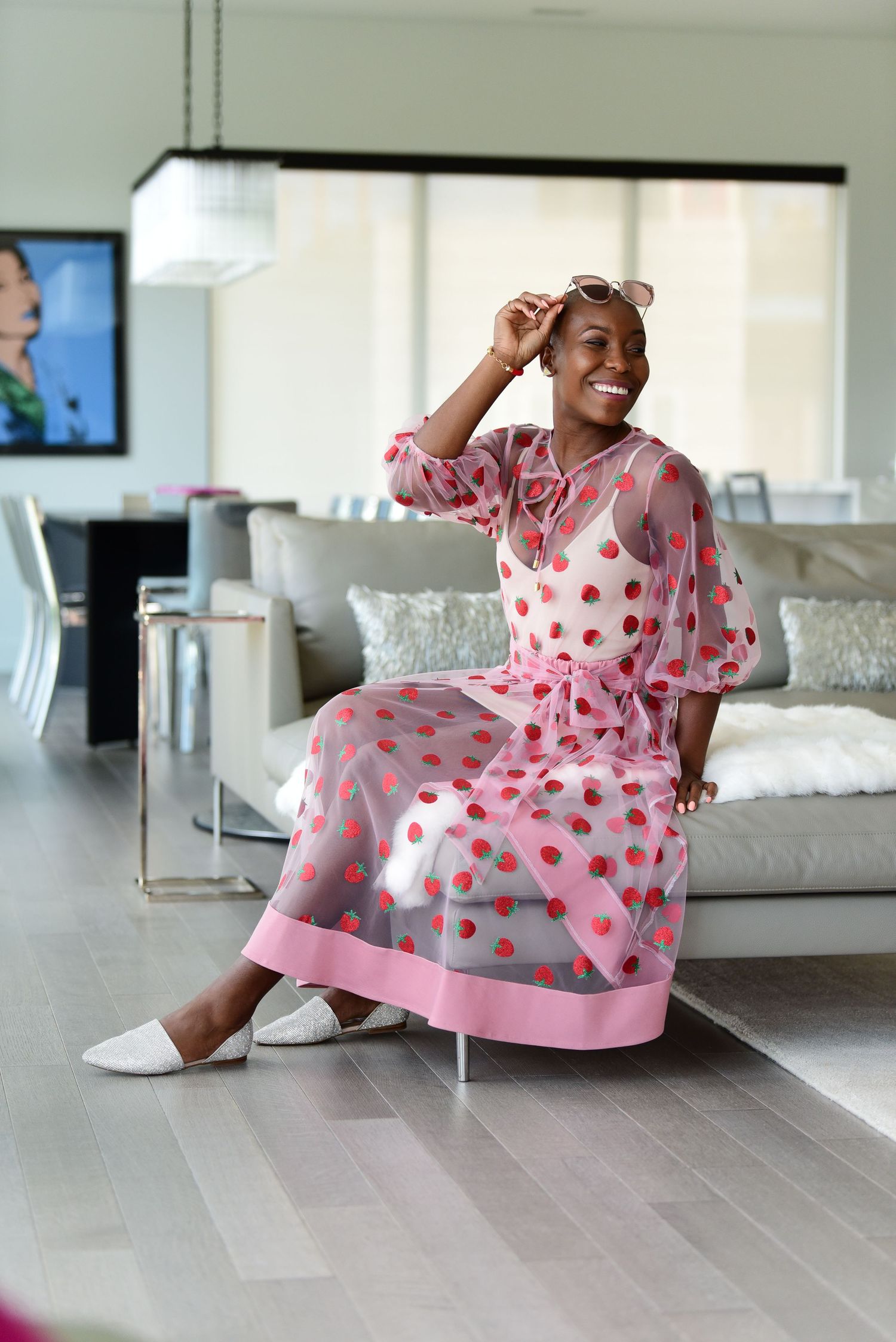 Pink polka dot dress twirling sequence on light wood floors in a modern living room.