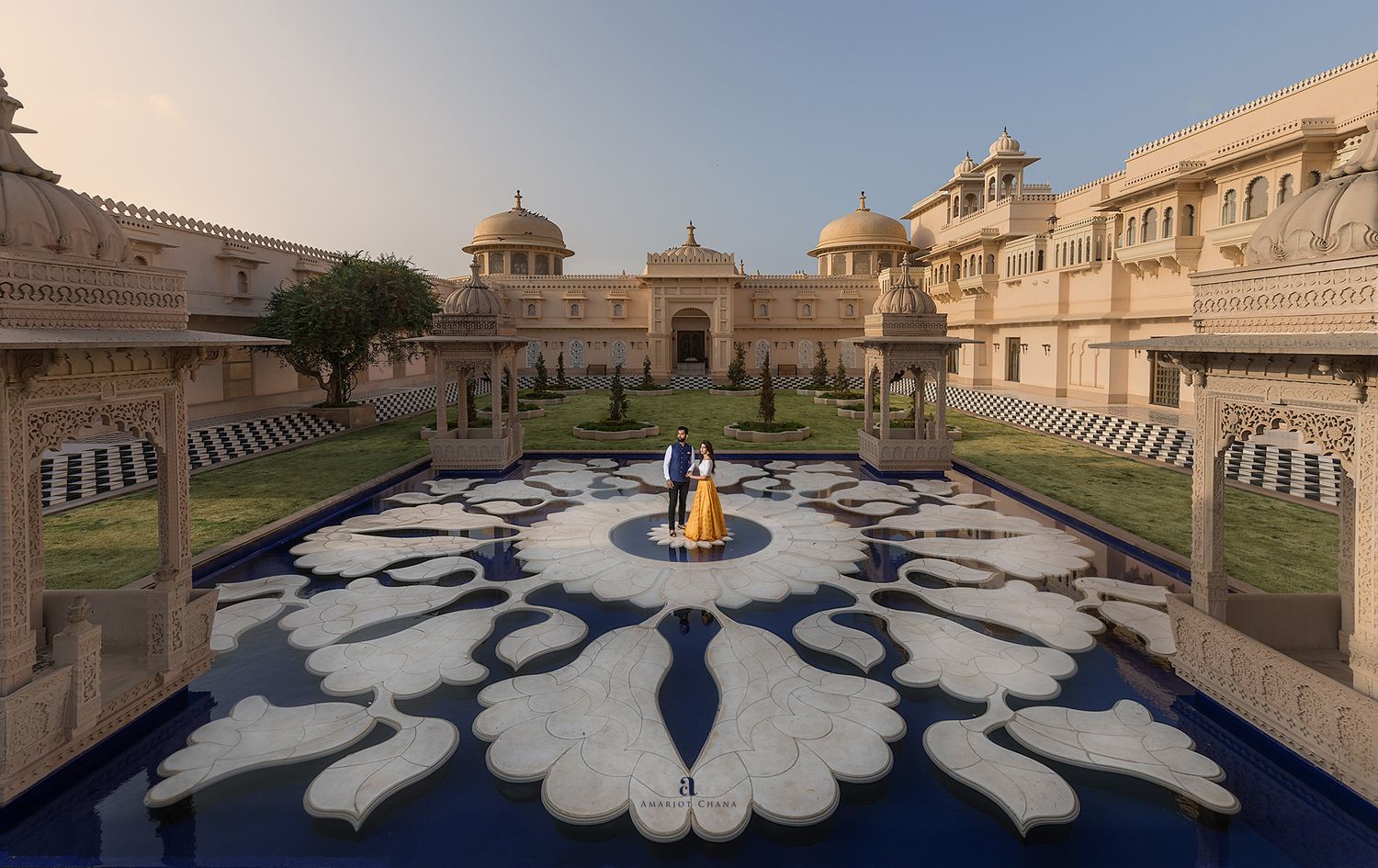 Prash and Amee pre-wedding shoot – couple standing on ornate white marble courtyard of majestic Indian palace at golden hour, destination