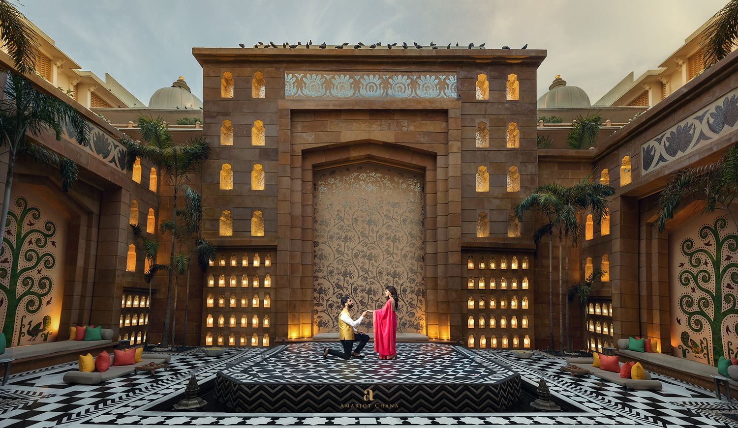 Robin and Jyoti pre-wedding shoot – couple sharing romantic moment on dramatic illuminated Indian palace stage with cascading water backdrop