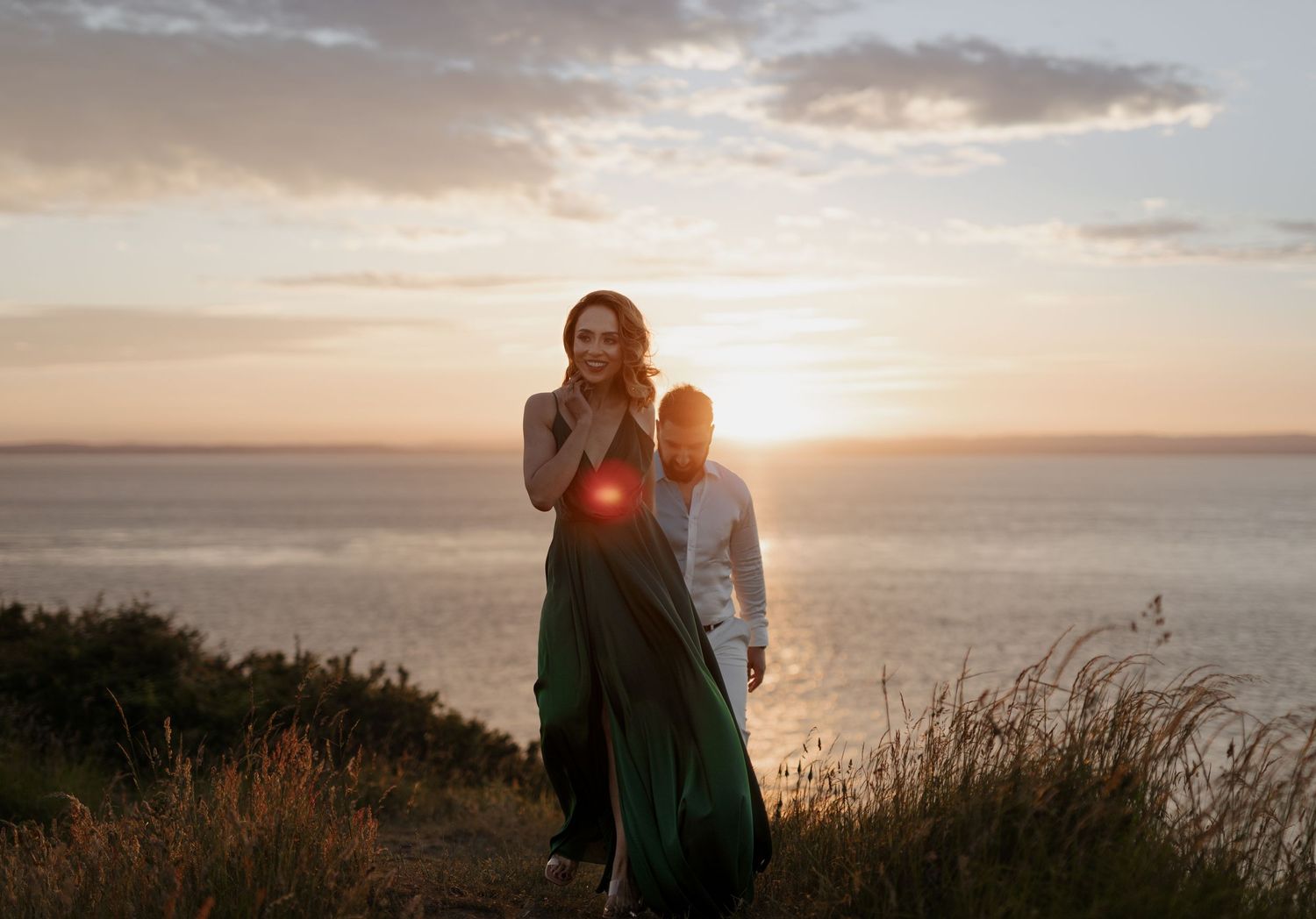 Pre-wedding portraits – couple embracing at coastal cliff edge at golden sunset, cinematic Indian wedding photography by Amarjot Chana
